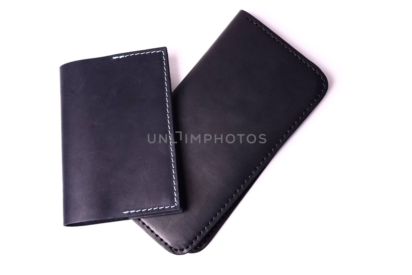 Black handmade leather man wallet and passport cover isolated on by alexsdriver