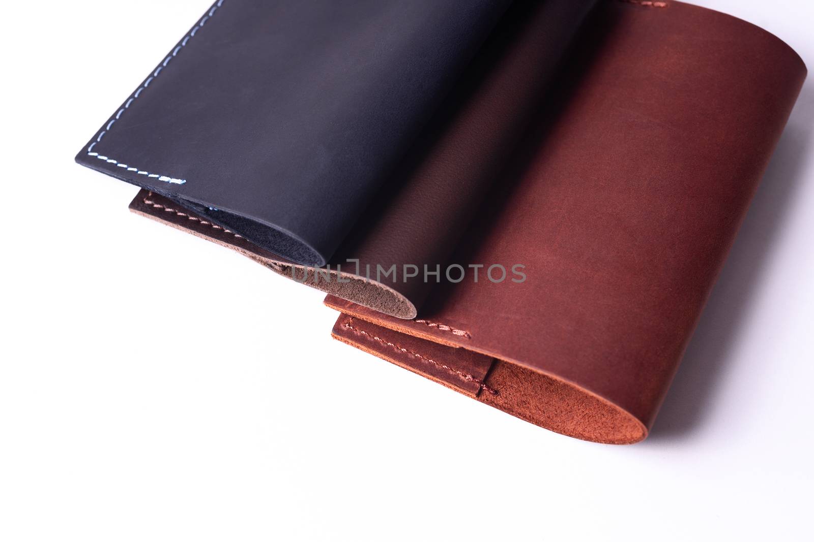 Three handmade leather passport covers isolated on white backgro by alexsdriver