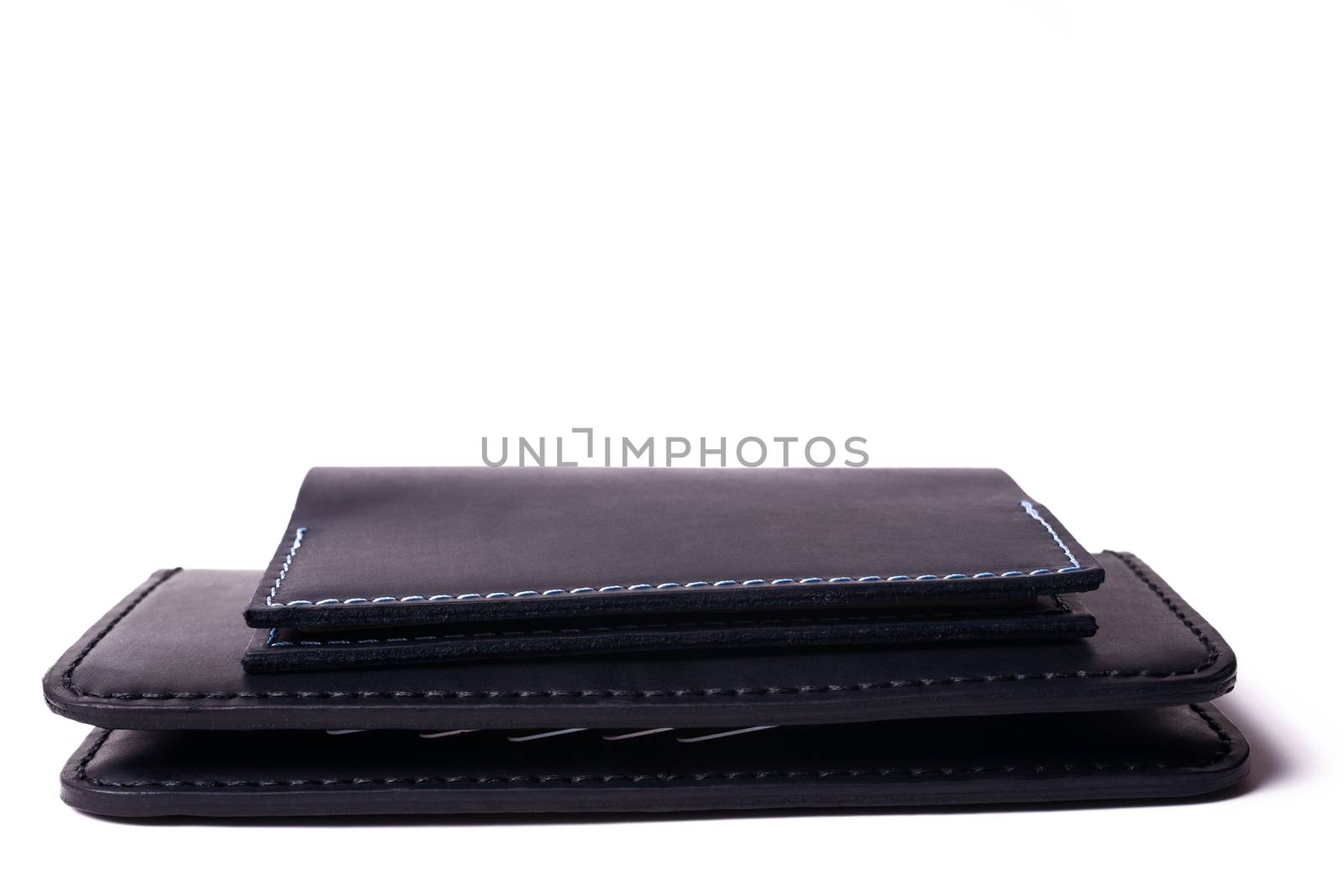 Black handmade leather man wallet and passport cover isolated on white background. Purse and cover are closed. Stock photo of luxury businessman accessories.