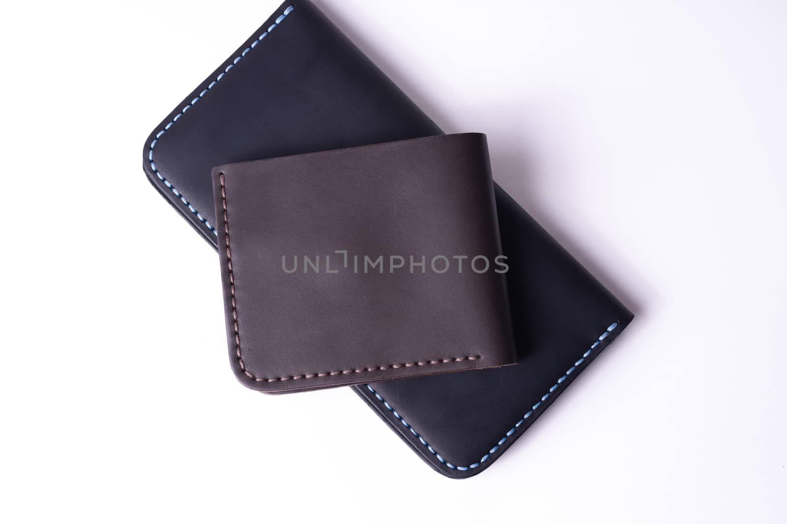 Handmade leather black purse and brown wallet isolated on white  by alexsdriver