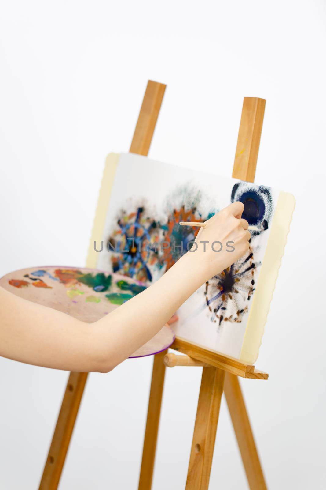 Close up of artist painting on an easel
