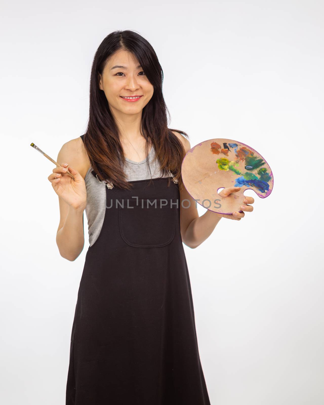 Artist holding painting palette and brush