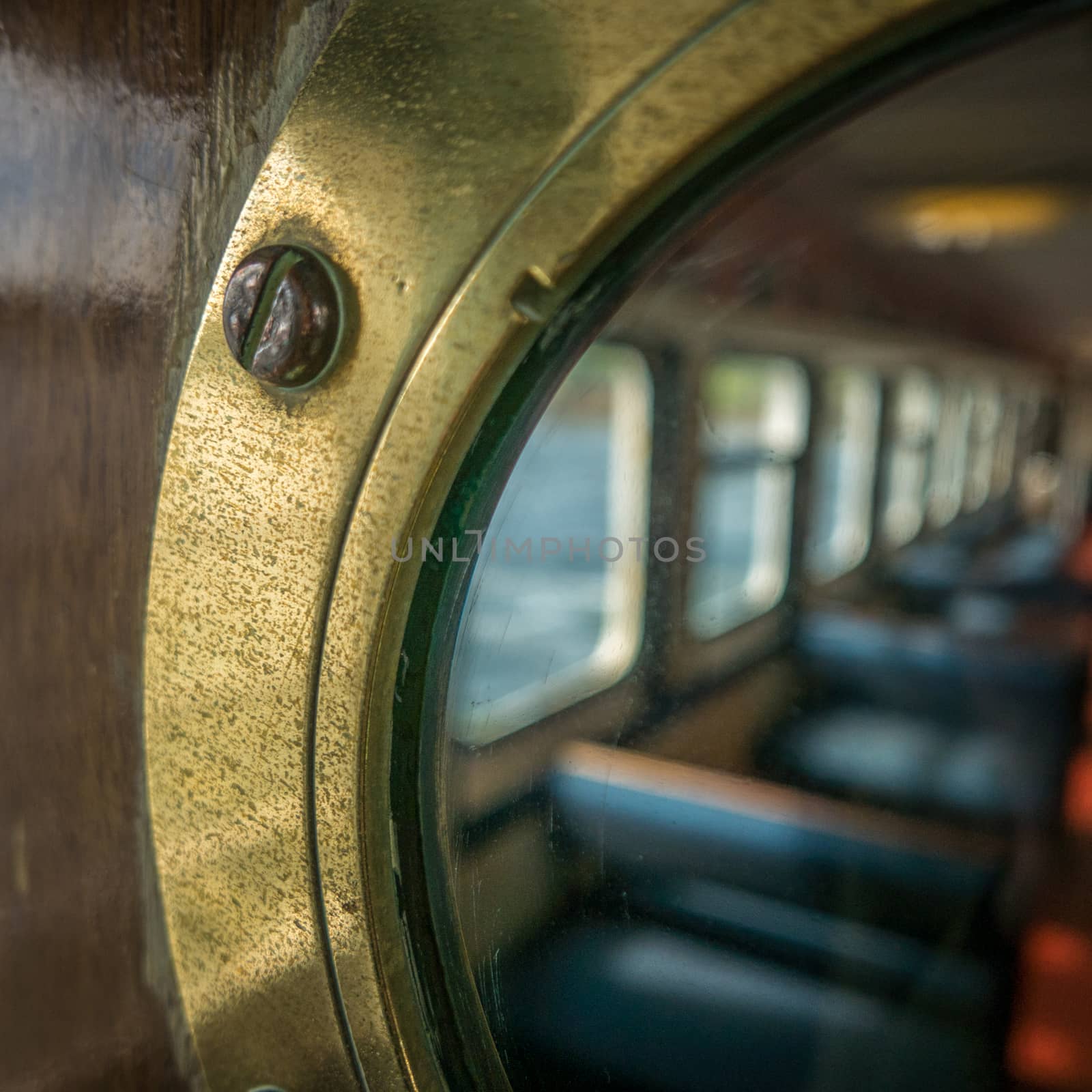 Passenger Seating Through A Brass Porthole On A Ship Or Ferry