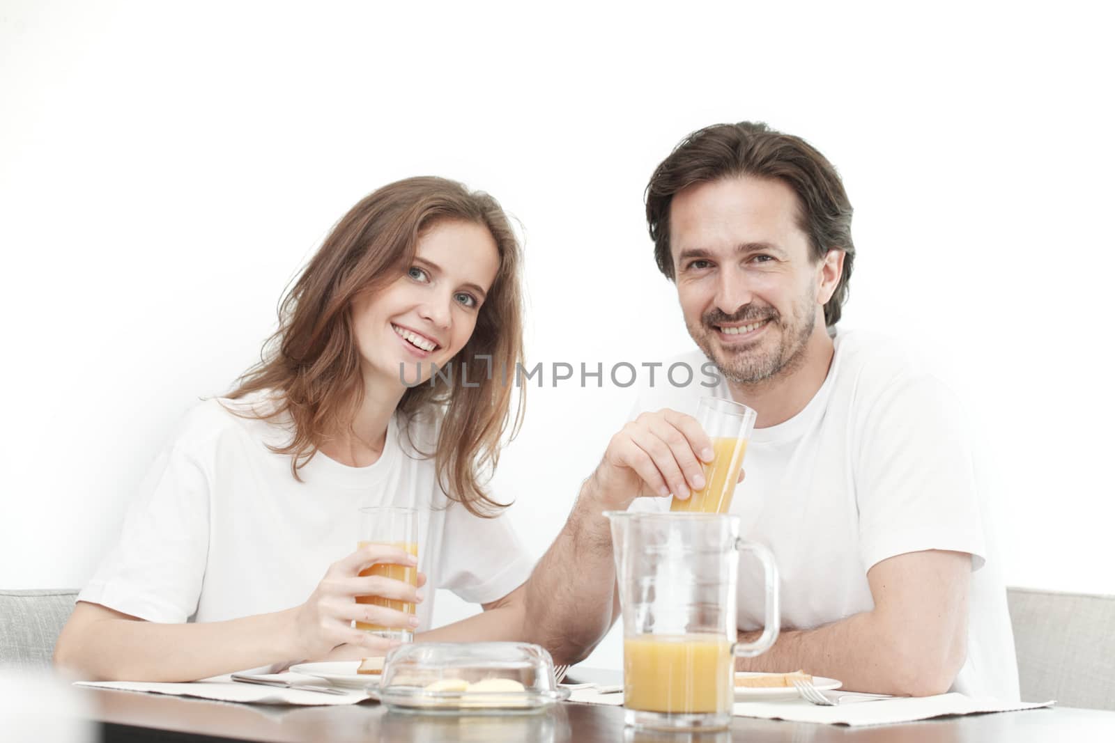 Portrait of couple having breakfast together, isolated on white background