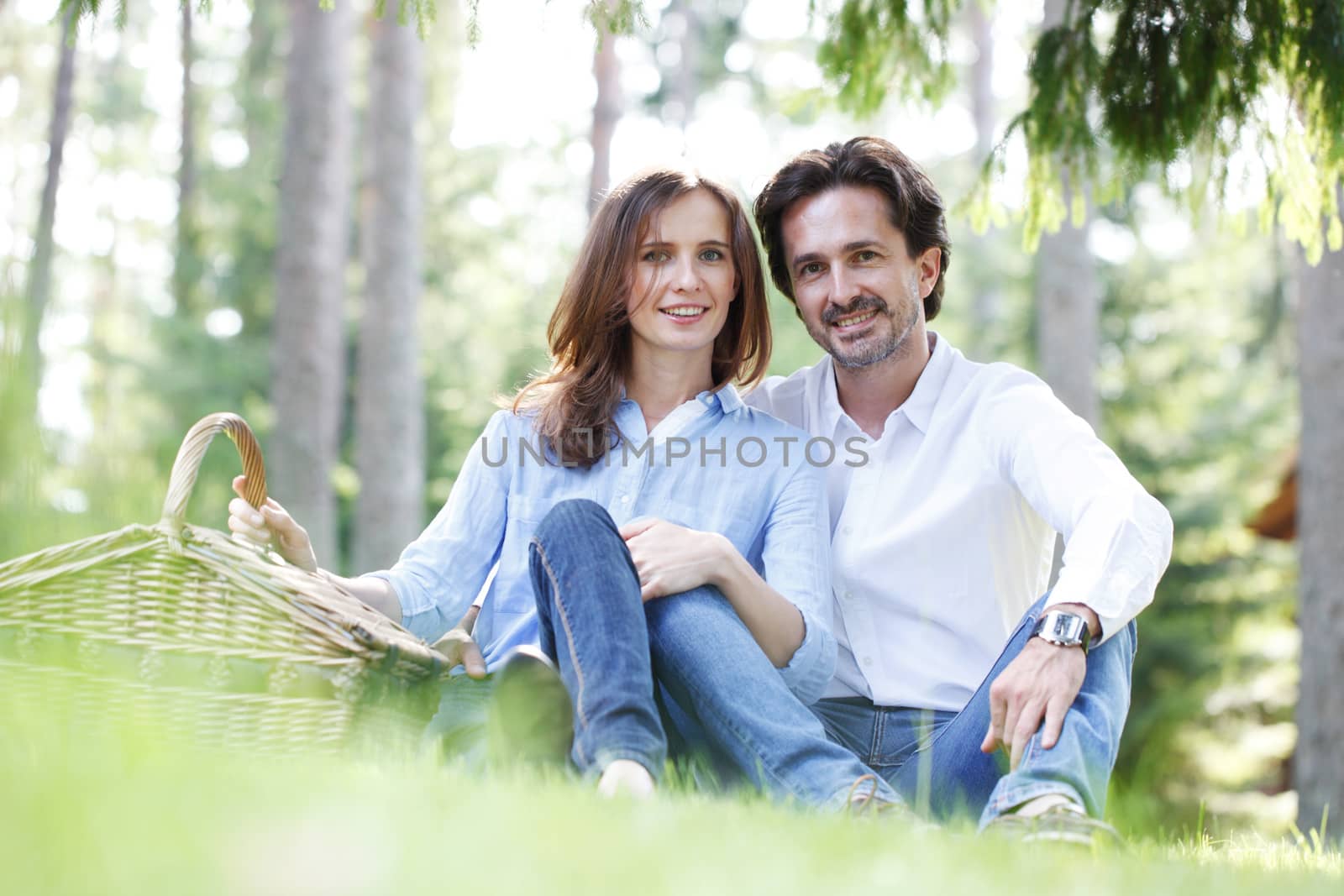 Young beautiful couple on picnic in summer park