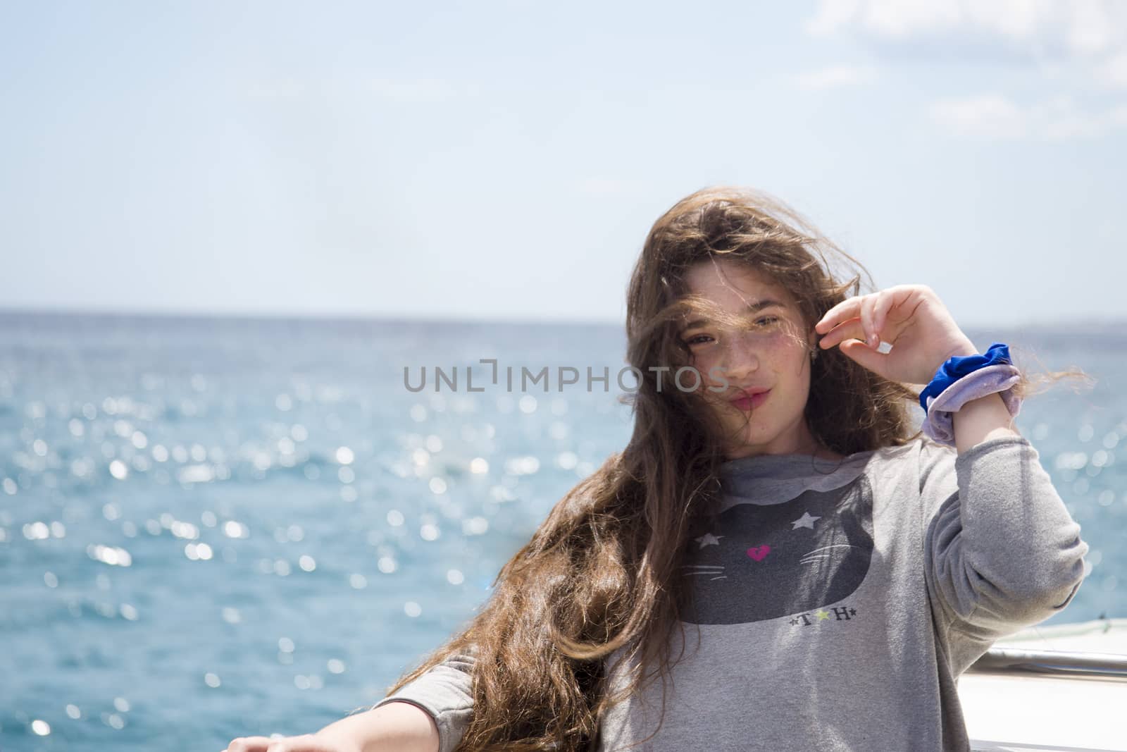 A young girl with long hair in a sea voyage on a pleasure boat. by Anelik