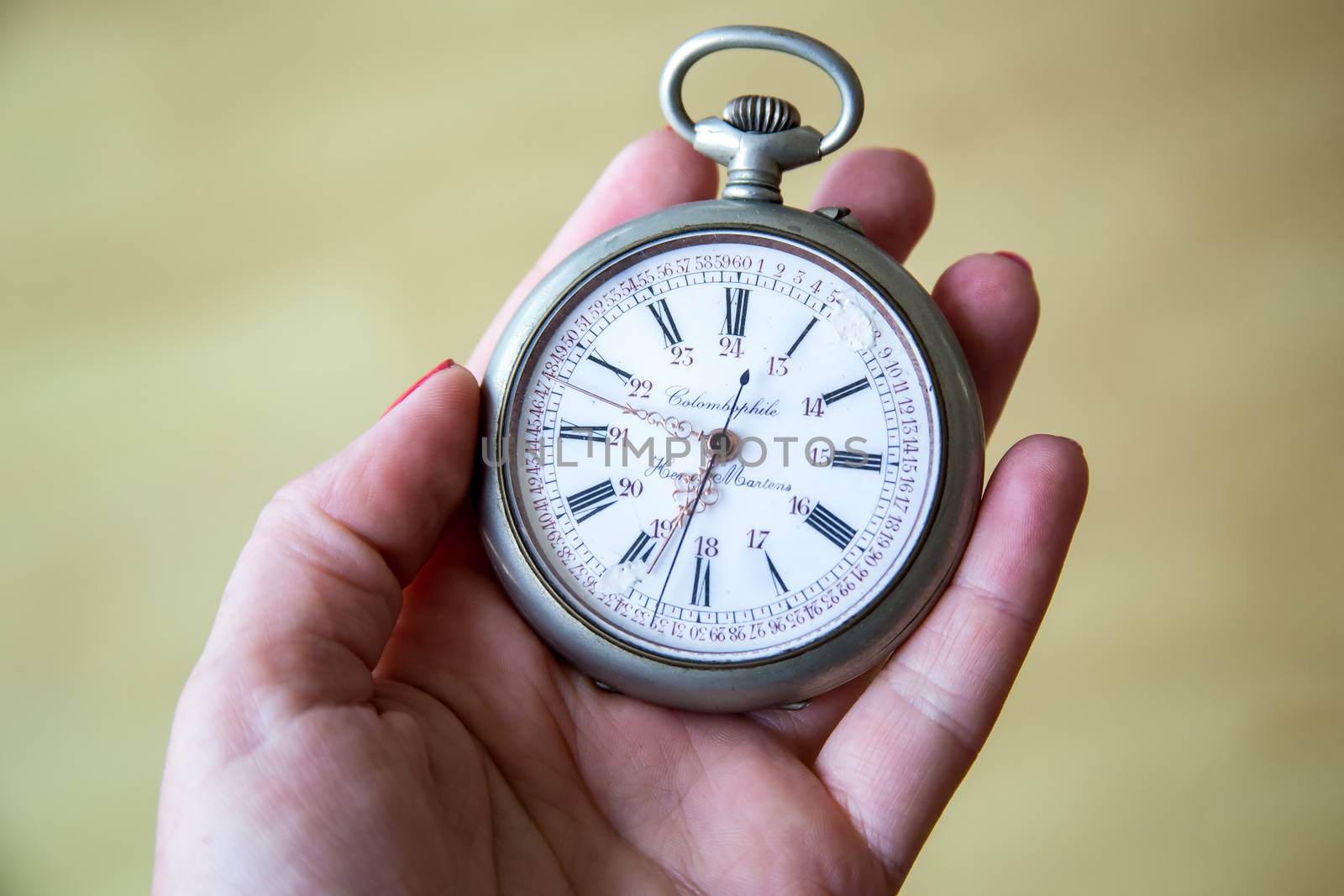 close up of hands with vintage pocket watch retro by Anelik