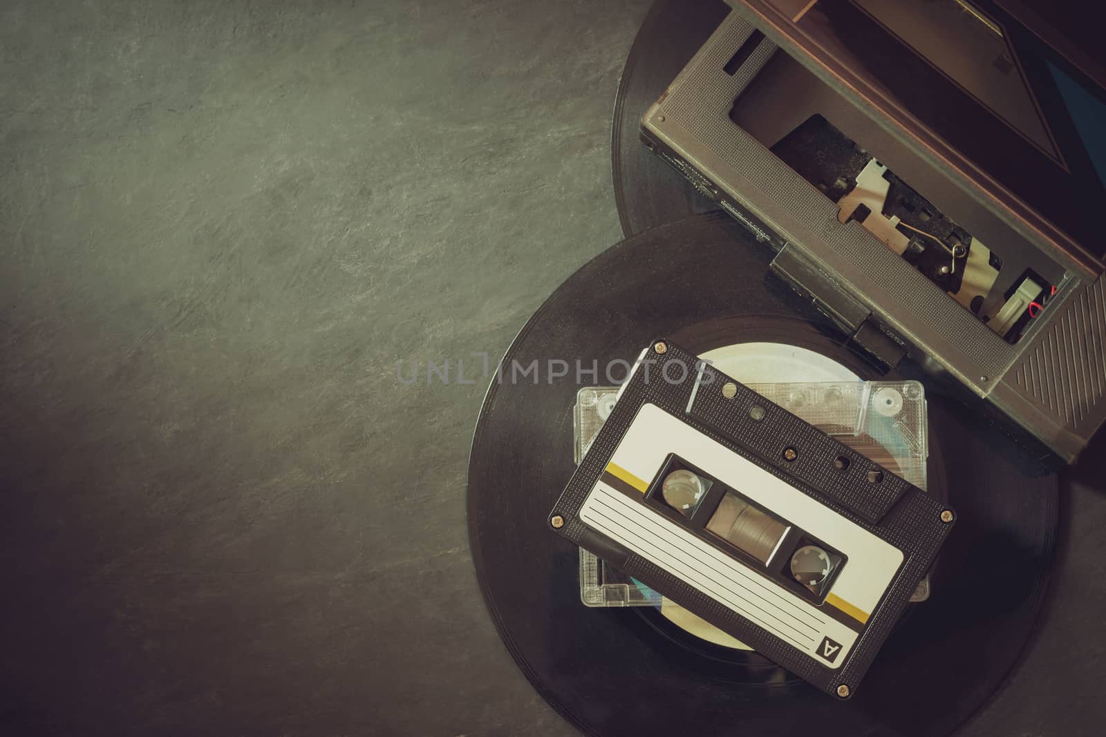 Cassette player and platter record on cement floor. Top view and by SaitanSainam