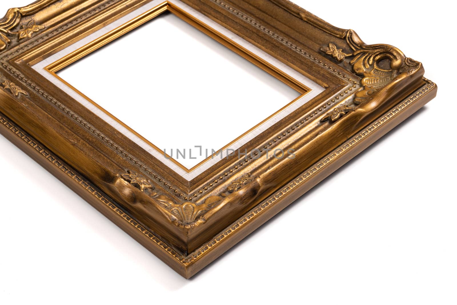 Ornate wood golden picture frame isolated on white.