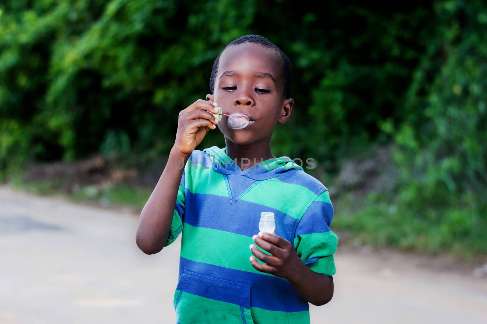Boy is having fun blowing bubbles.
