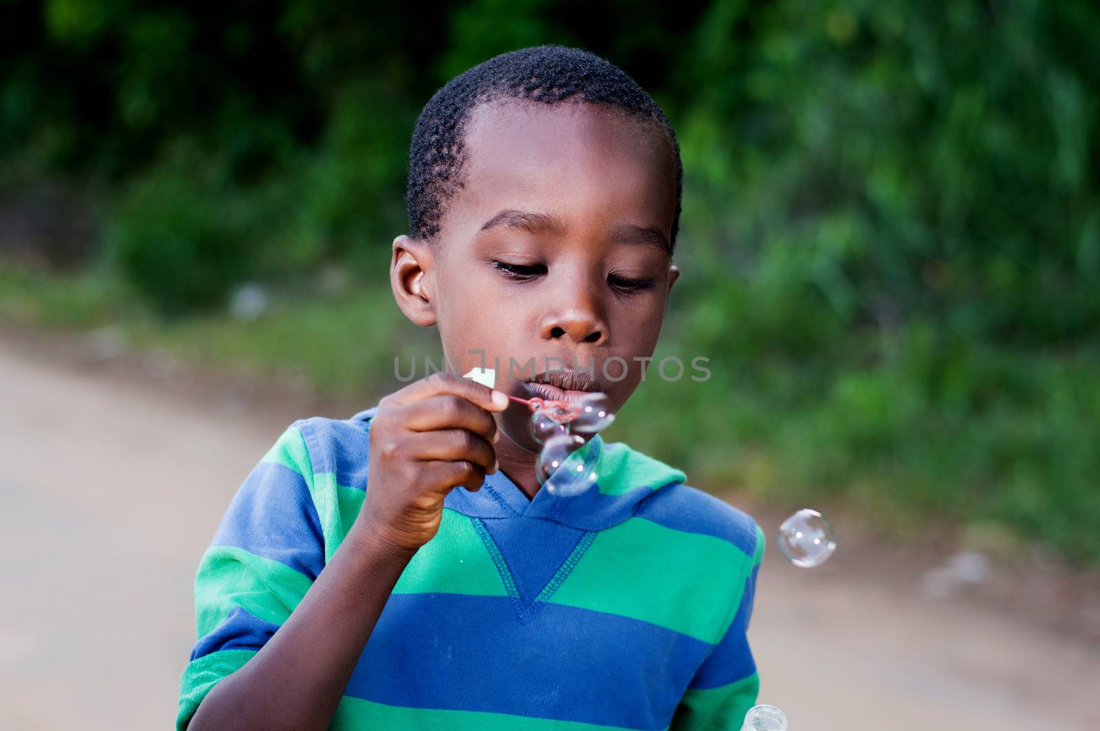 Boy is having fun blowing bubbles.