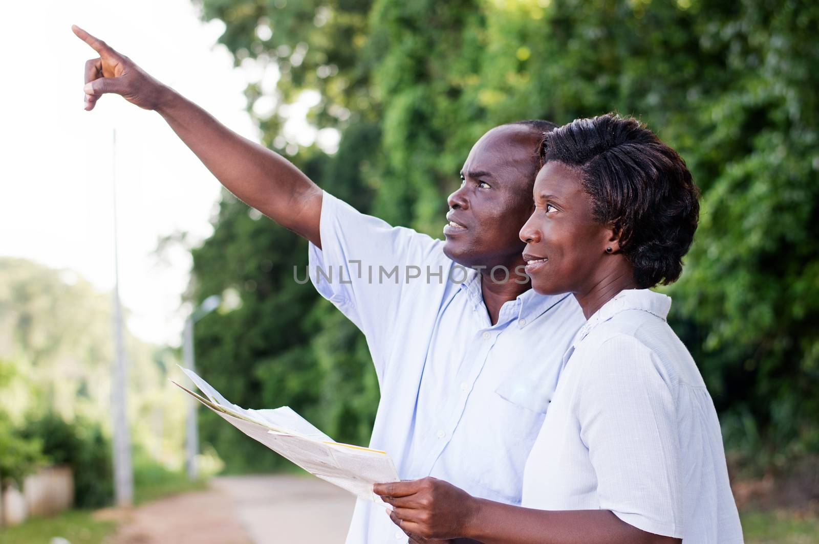 happy couple walking in the countryside and points to something.