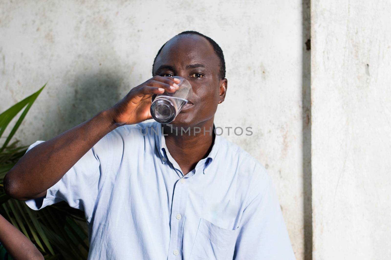 middle-aged man drinking water in a glass