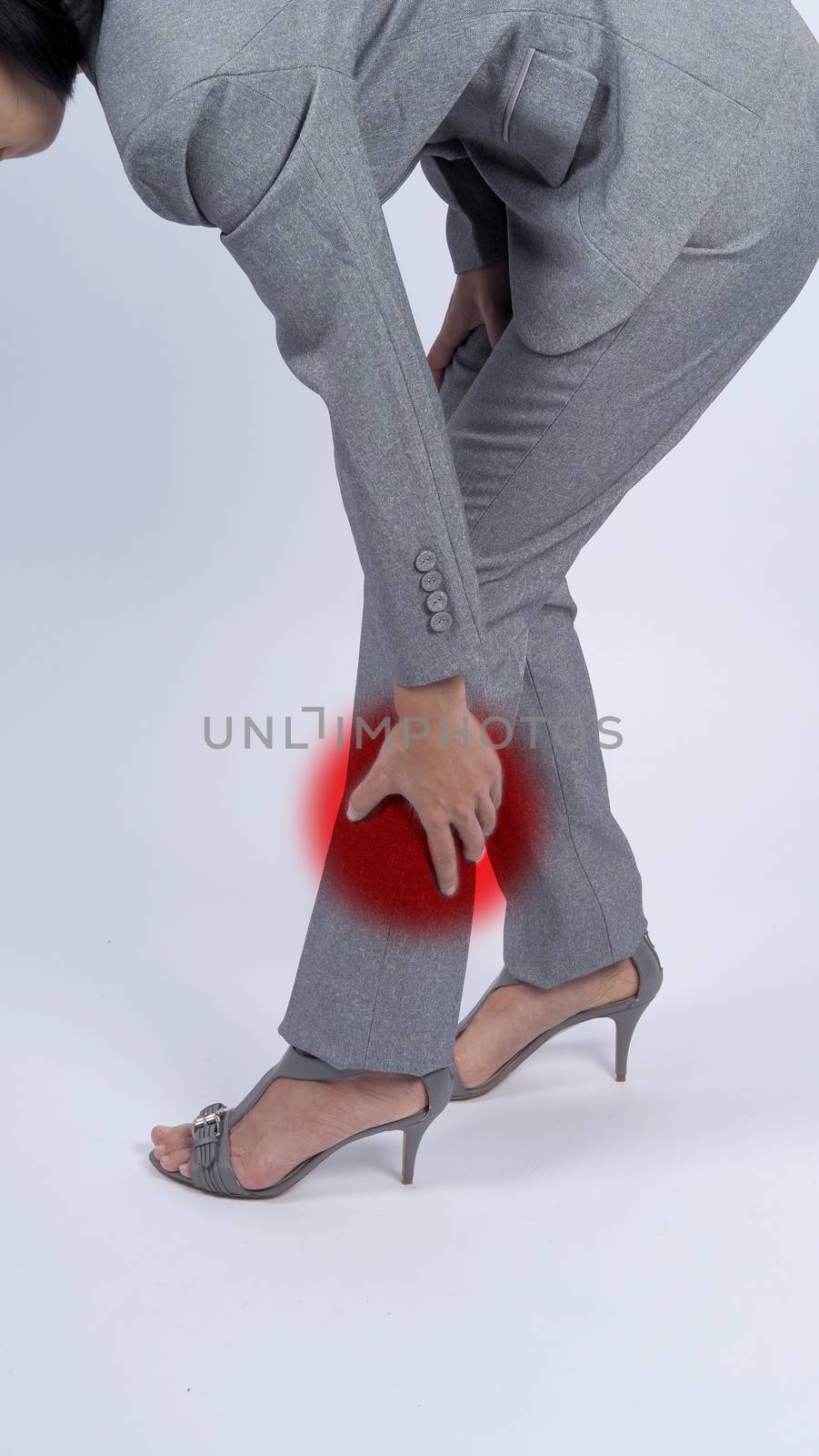 Business woman muscle suffering or painful from myositis or office syndrome or working which represent pain point by red gradient dot color and grey color suit and white background