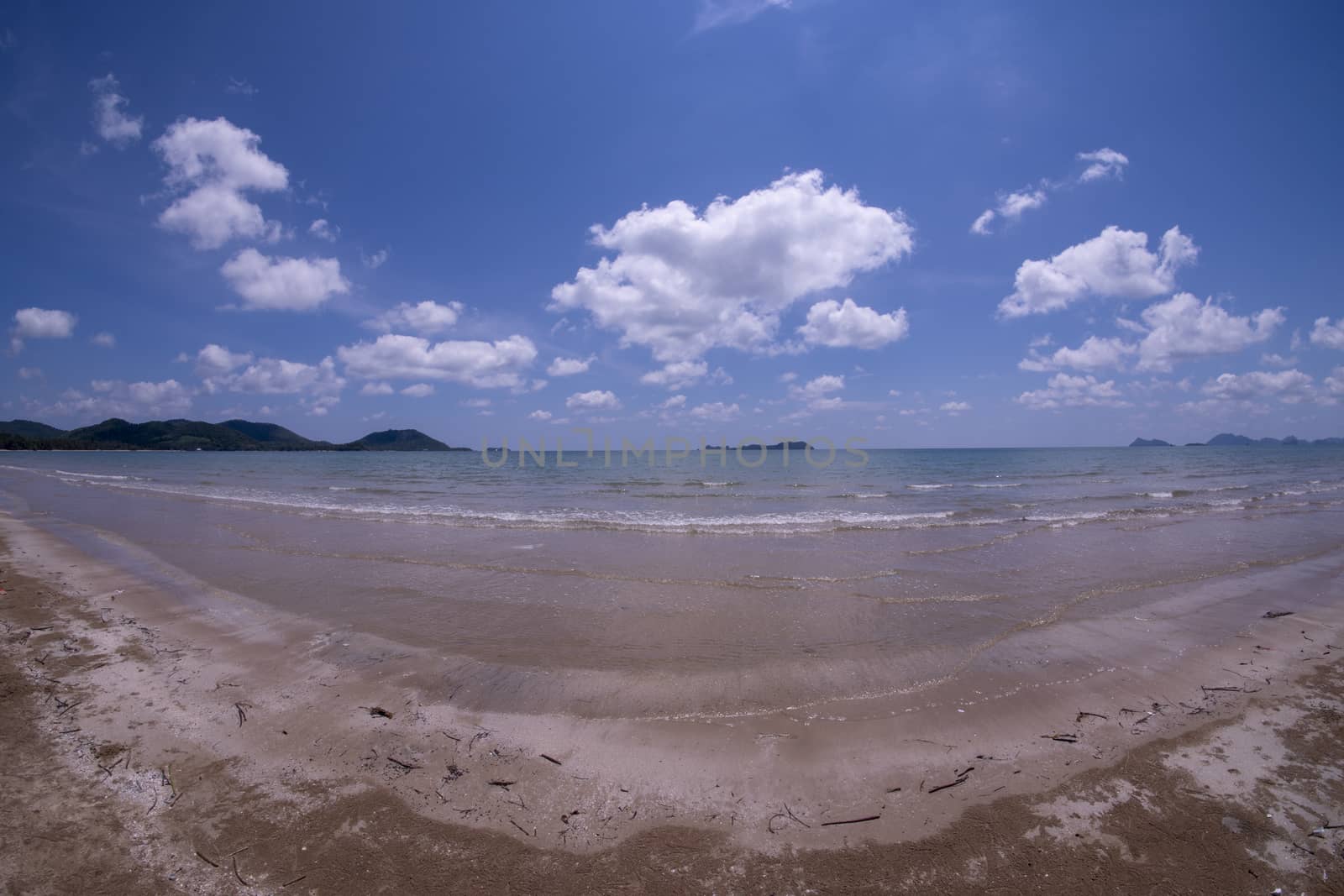 Daytime beach wide angle. Sairee Beach, March 2019. Fluffy white clouds and blue skies.
