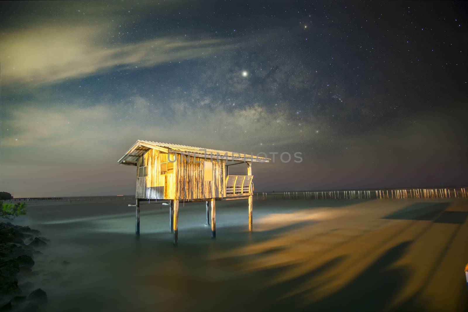 Old wooden house, no longer living in the sea, no way up the house Taken with the Milky Way as the back ground	
