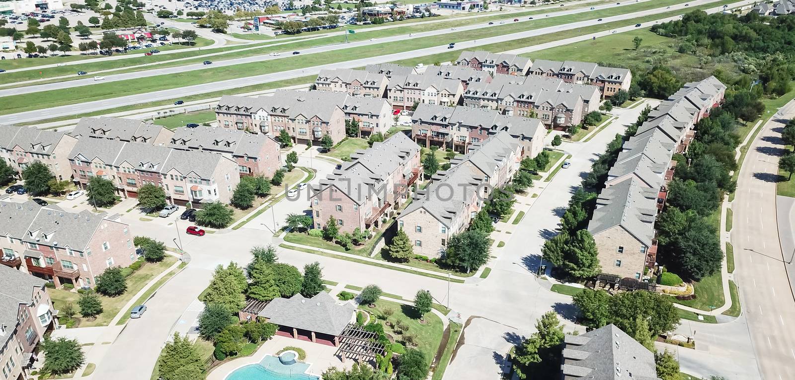 Panoramic aerial view apartment building with swimming pool near highway and shopping streets by trongnguyen