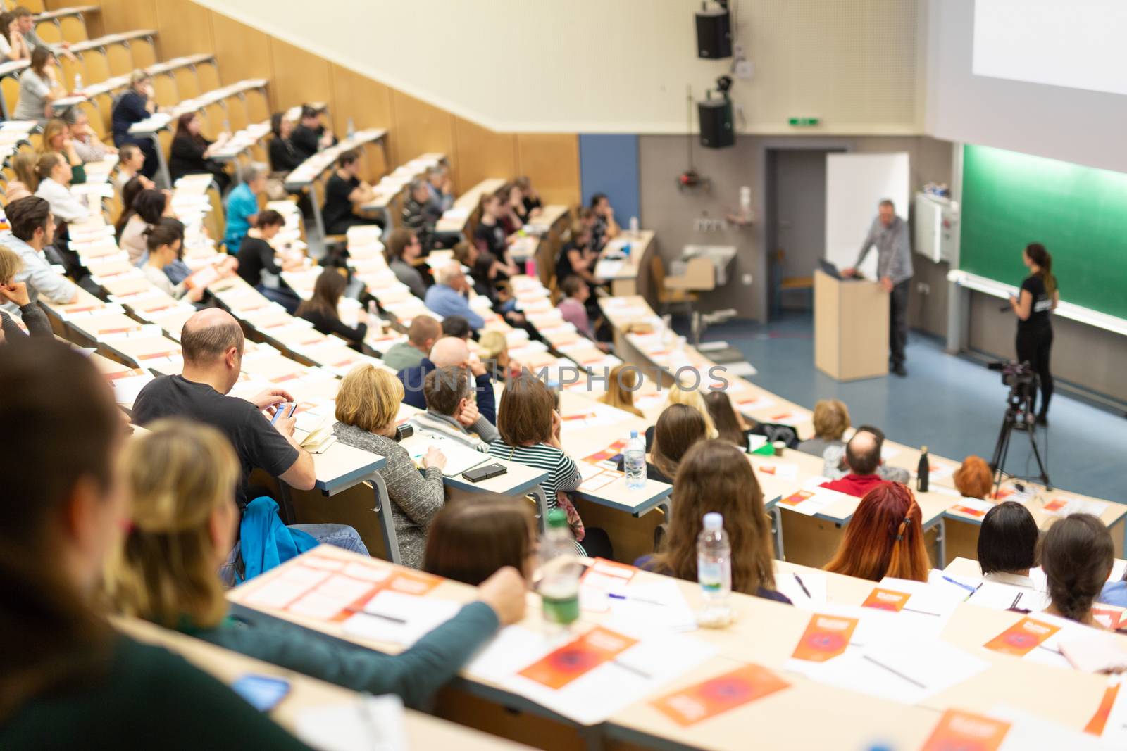 Conference and Presentation. Audience at the conference hall. Business and Entrepreneurship. Faculty lecture and workshop. Audience in the lecture hall. Academic education. Participants making notes.
