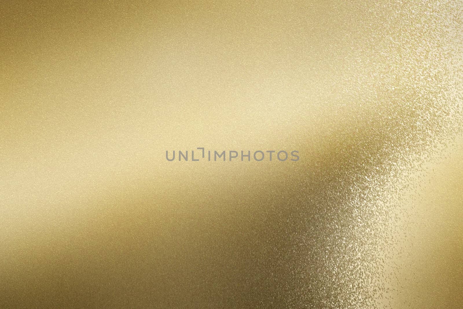 Glowing brushed gold foil metallic sheet, abstract texture background