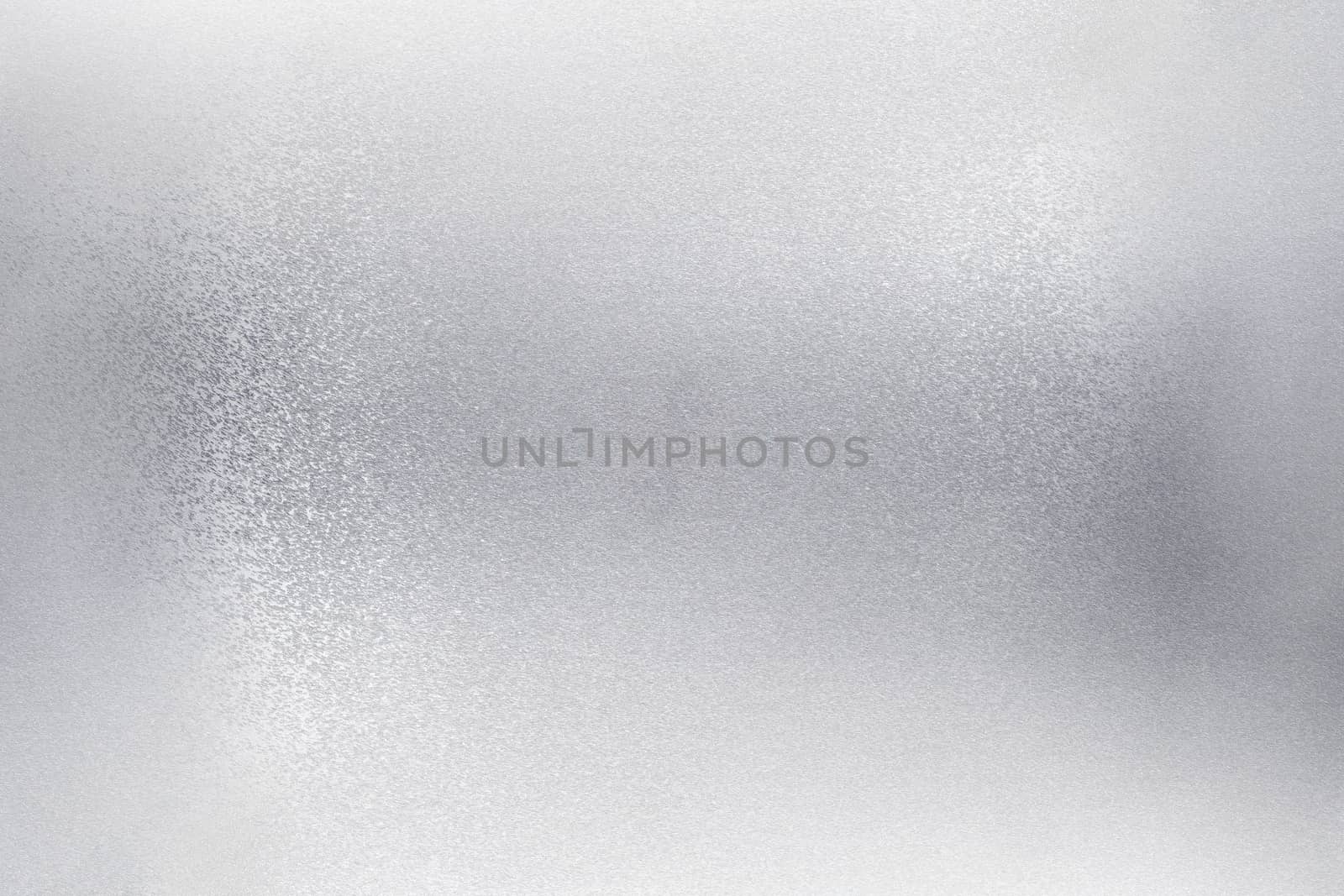 Glowing brushed silver foil metallic wall, abstract texture background