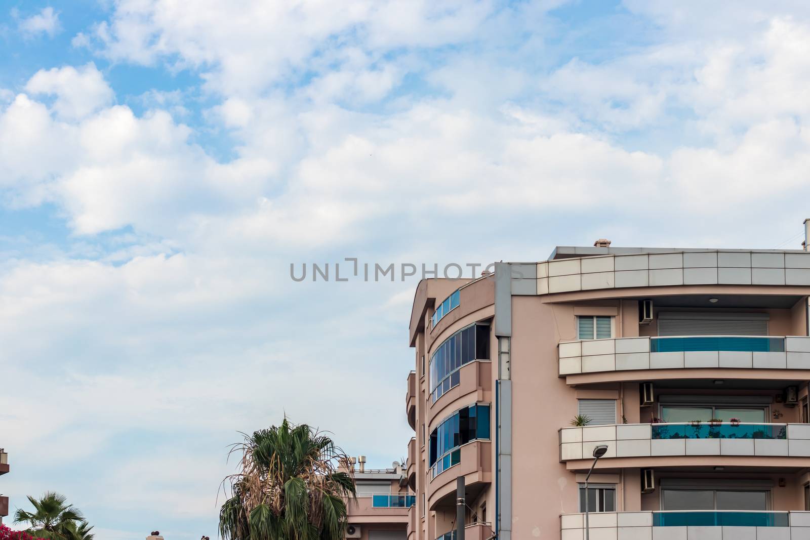 a wide corner shoot from an modern building with balcony - sky landscape as background. photo has taken at izmir/turkey.