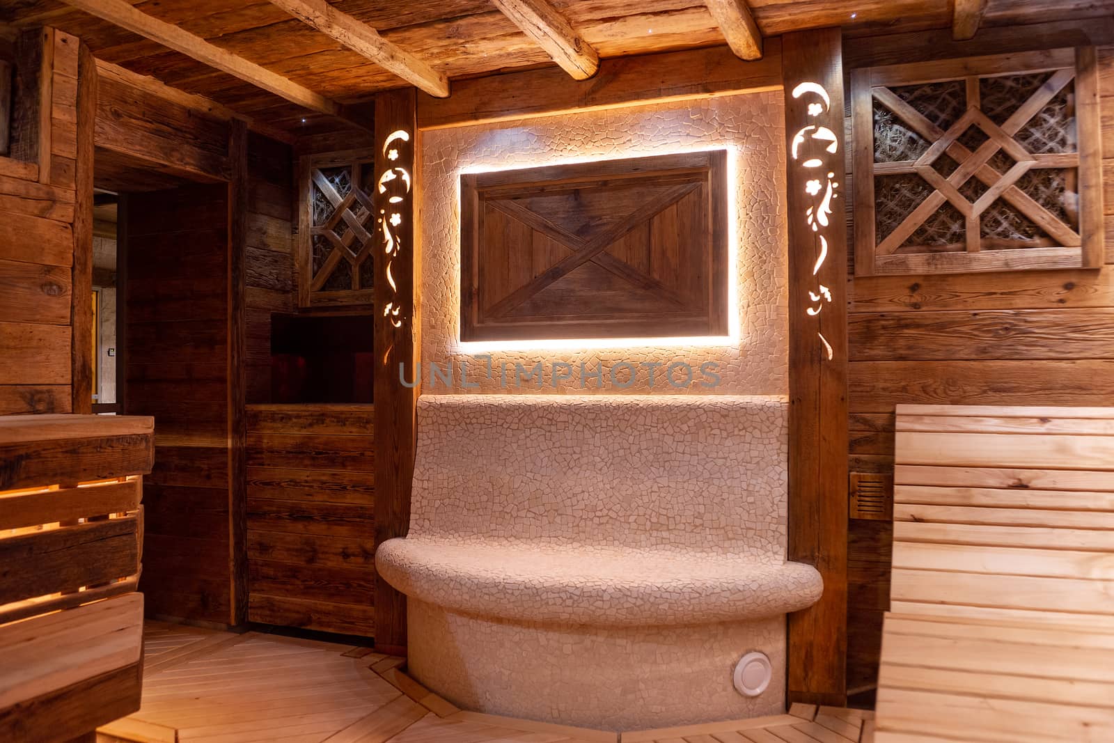 Handmade bath in the spa complex. The bath is trimmed with planks and hay.