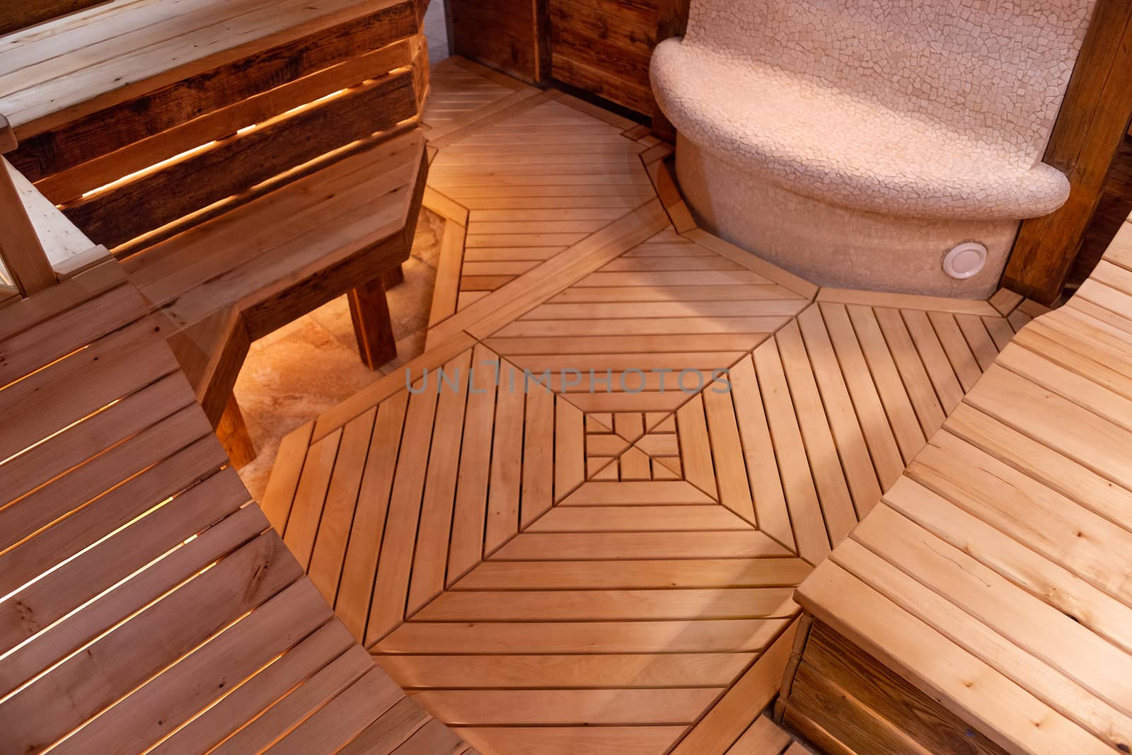 Handmade bath in the spa complex. The bath is trimmed with planks and hay.