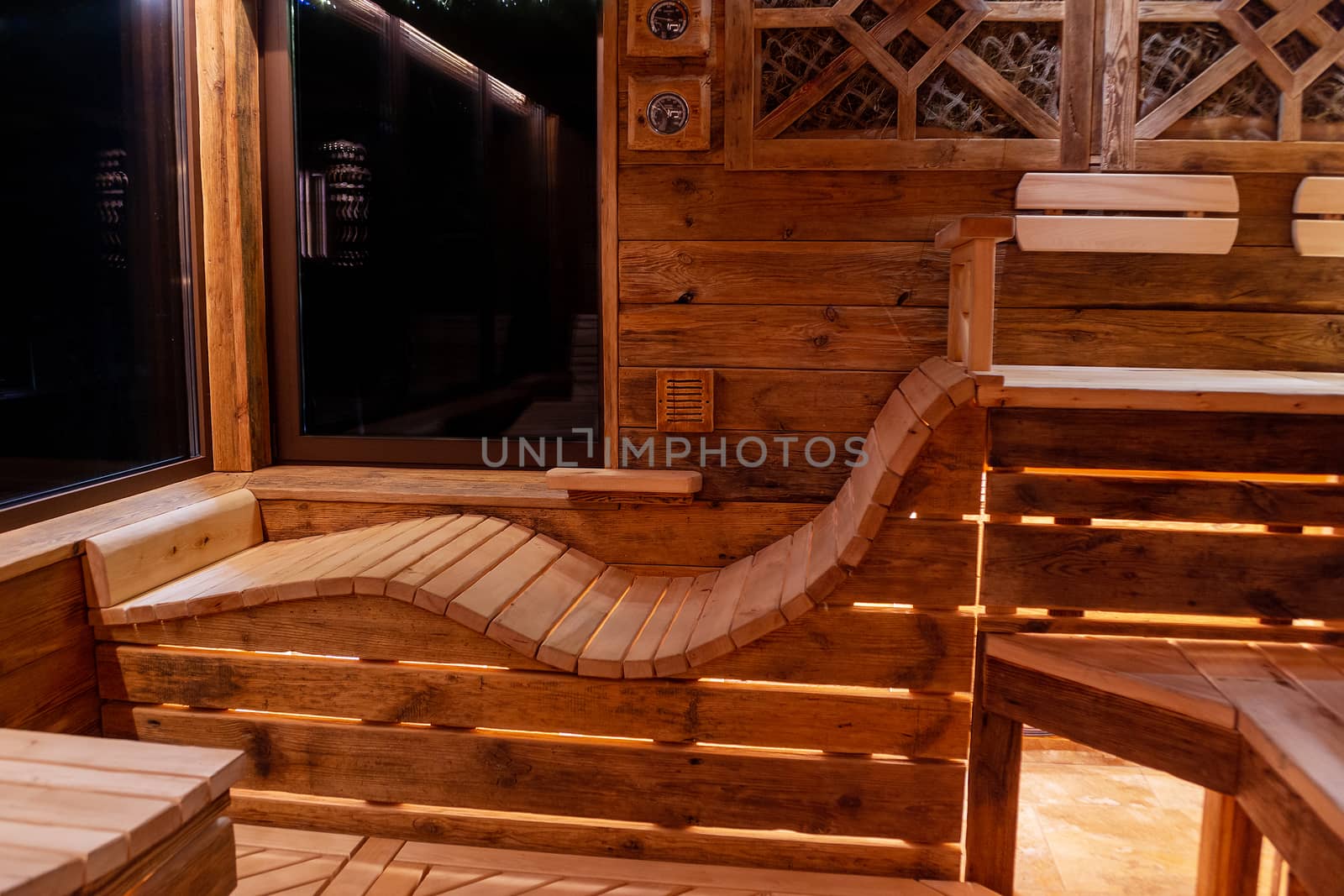 Handmade bath in the spa complex. The bath is trimmed with planks and hay.