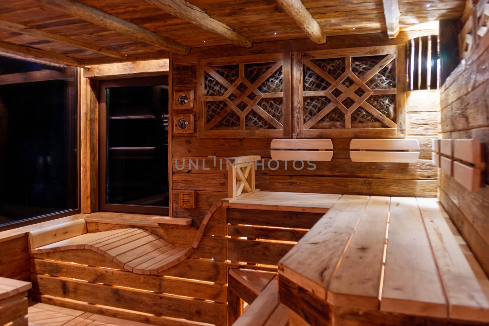 Handmade bath in the spa complex. The bath is trimmed with planks and hay.