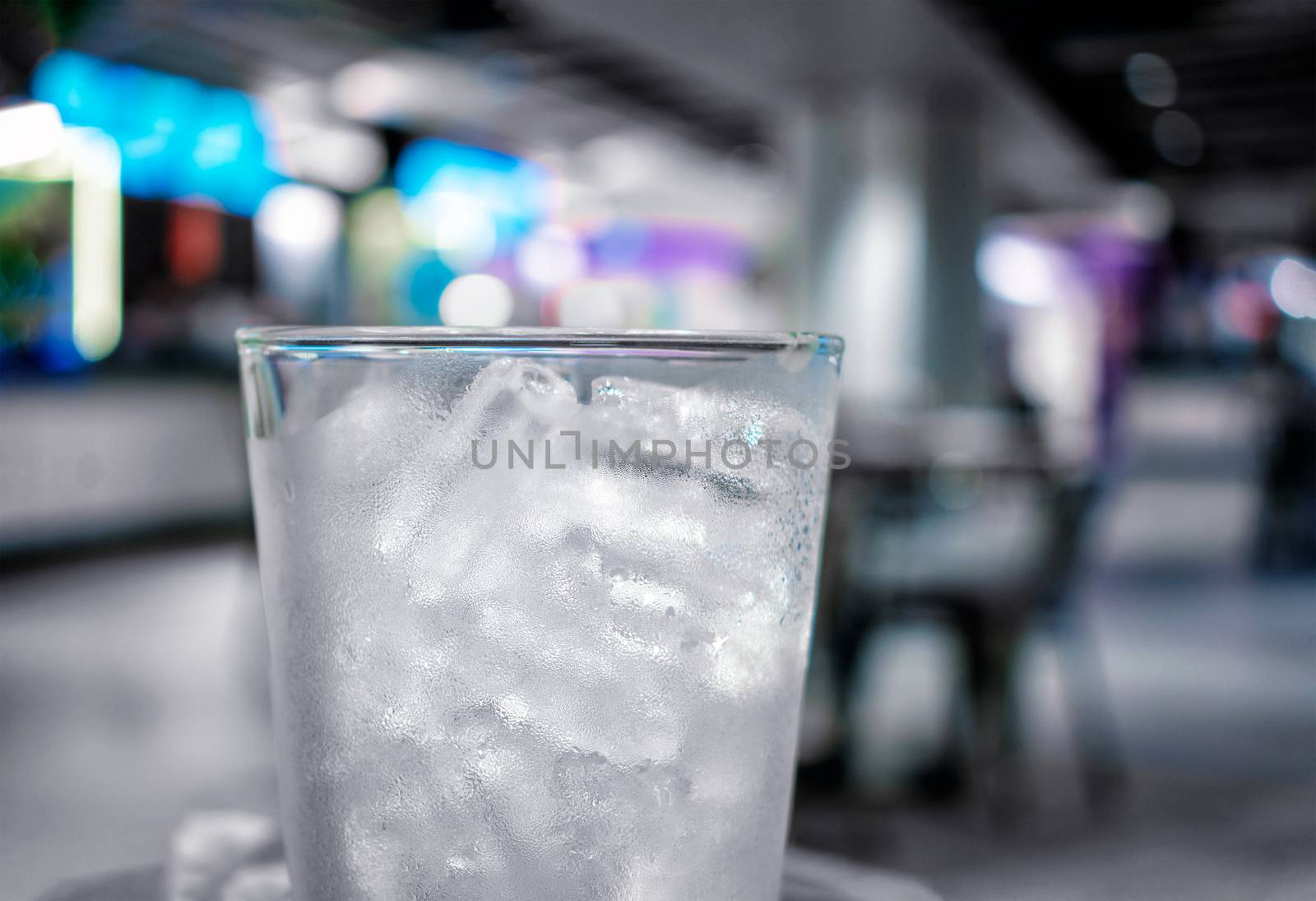 Frosted Chilled Glass Filled with Tubular Shaped Ice in a Bar
