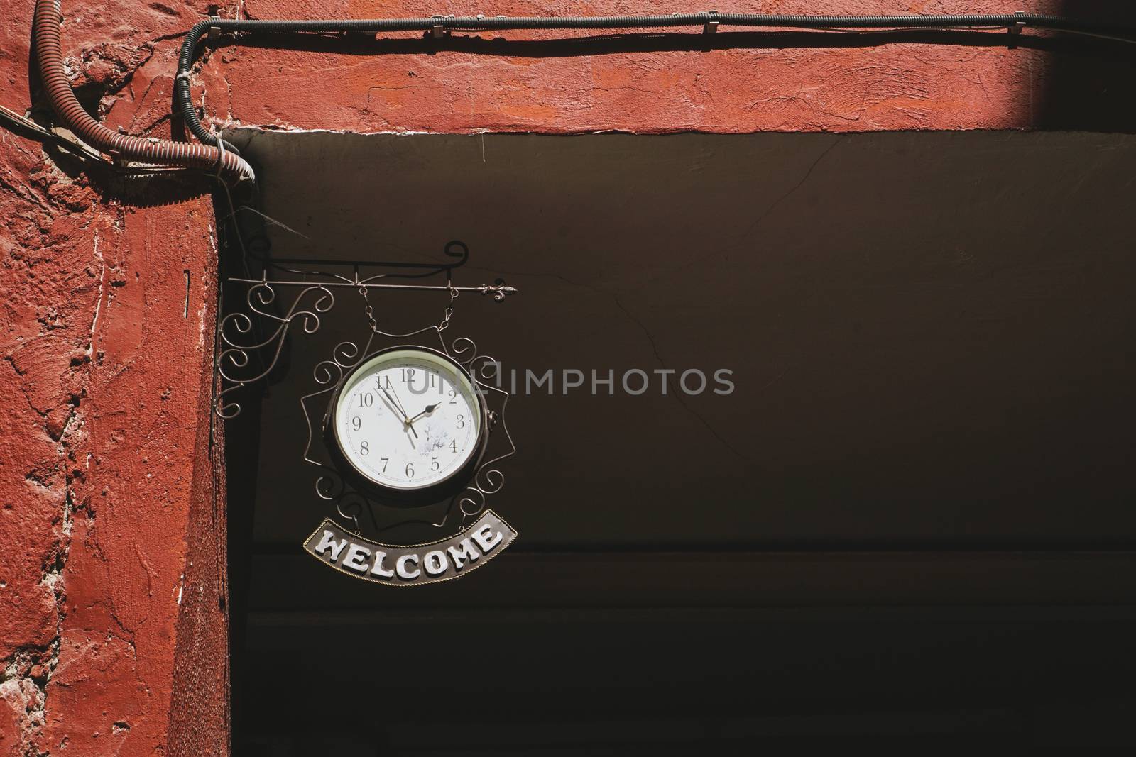 Clock with label Welcome. Red courtyard in Minsk