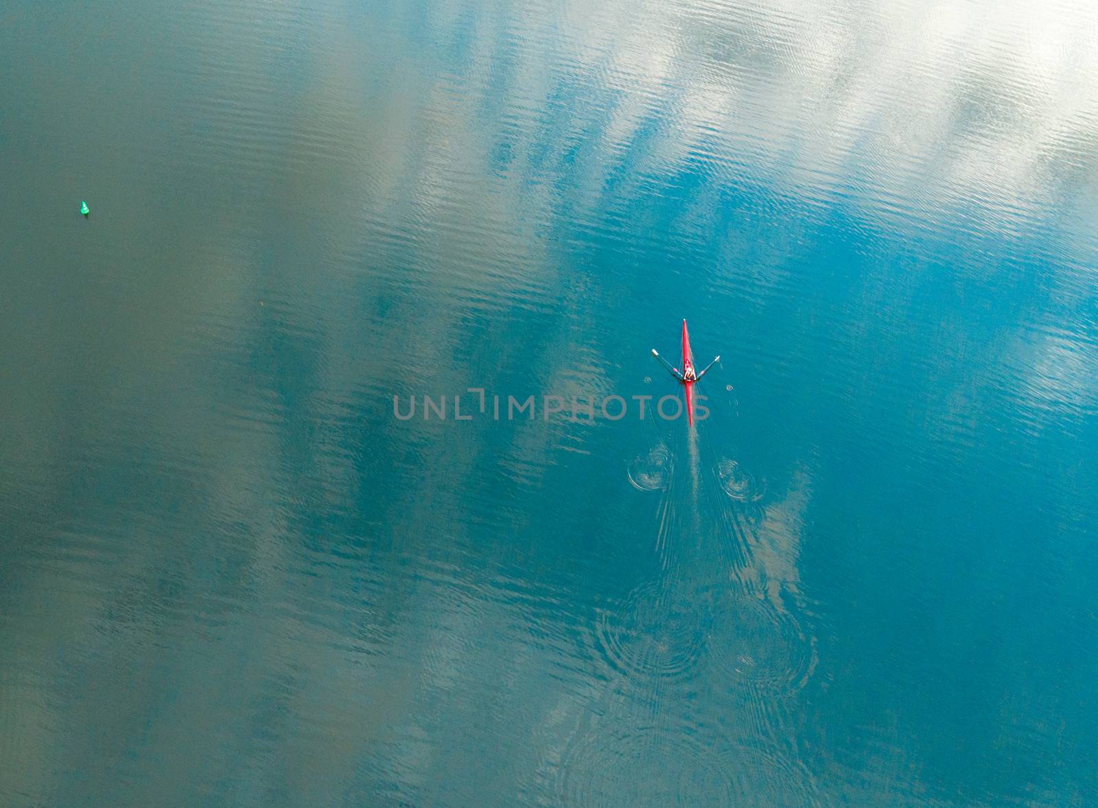 Kayaker rowing along the river.  Aerial top down with space for copy