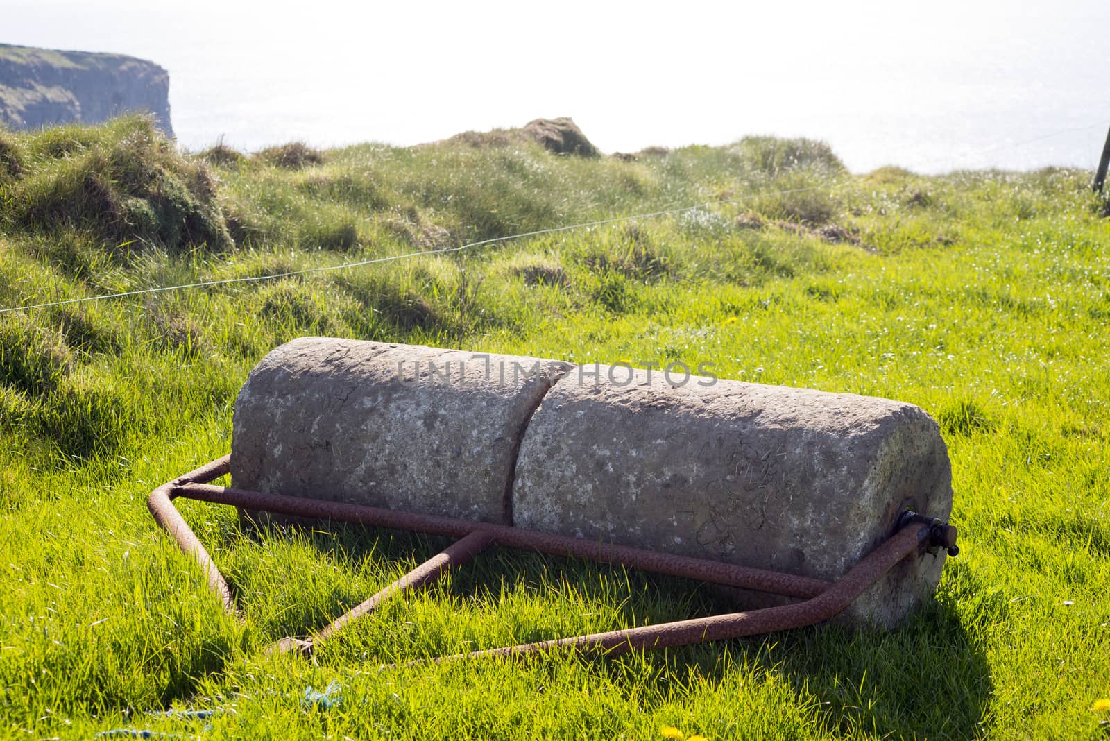 old rustic concrete roller abandoned at a field in ireland