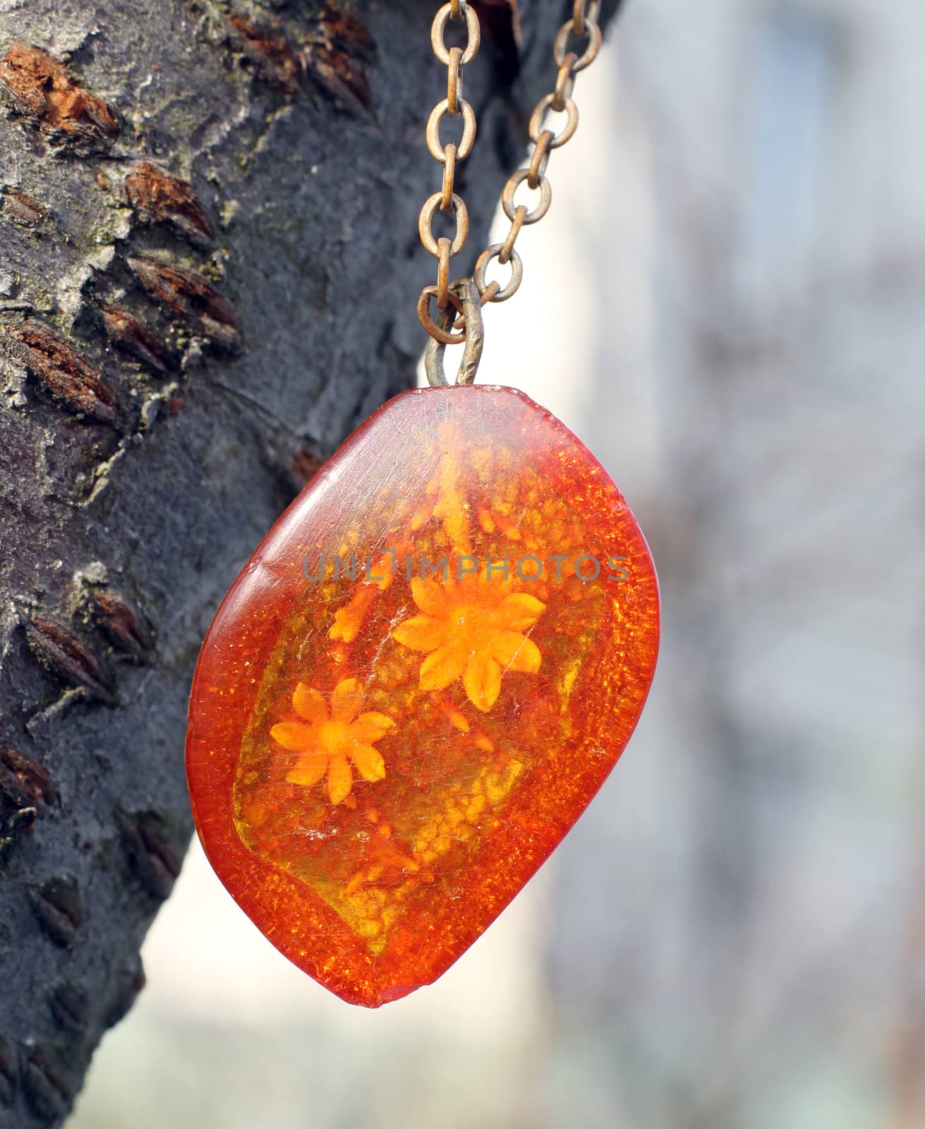 the old pendant with flower in amber