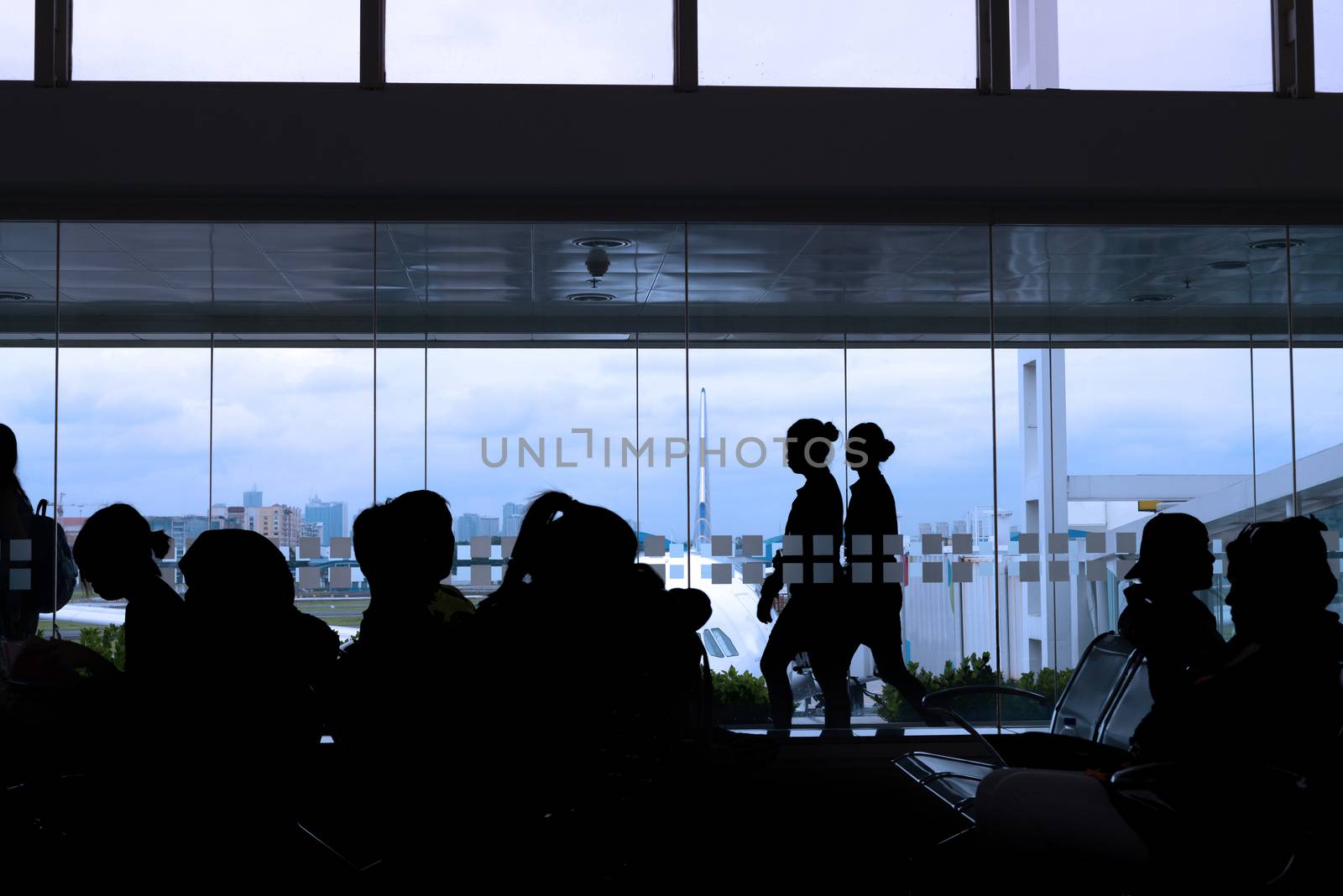 silhouette of crew and passengers at an airport lounge