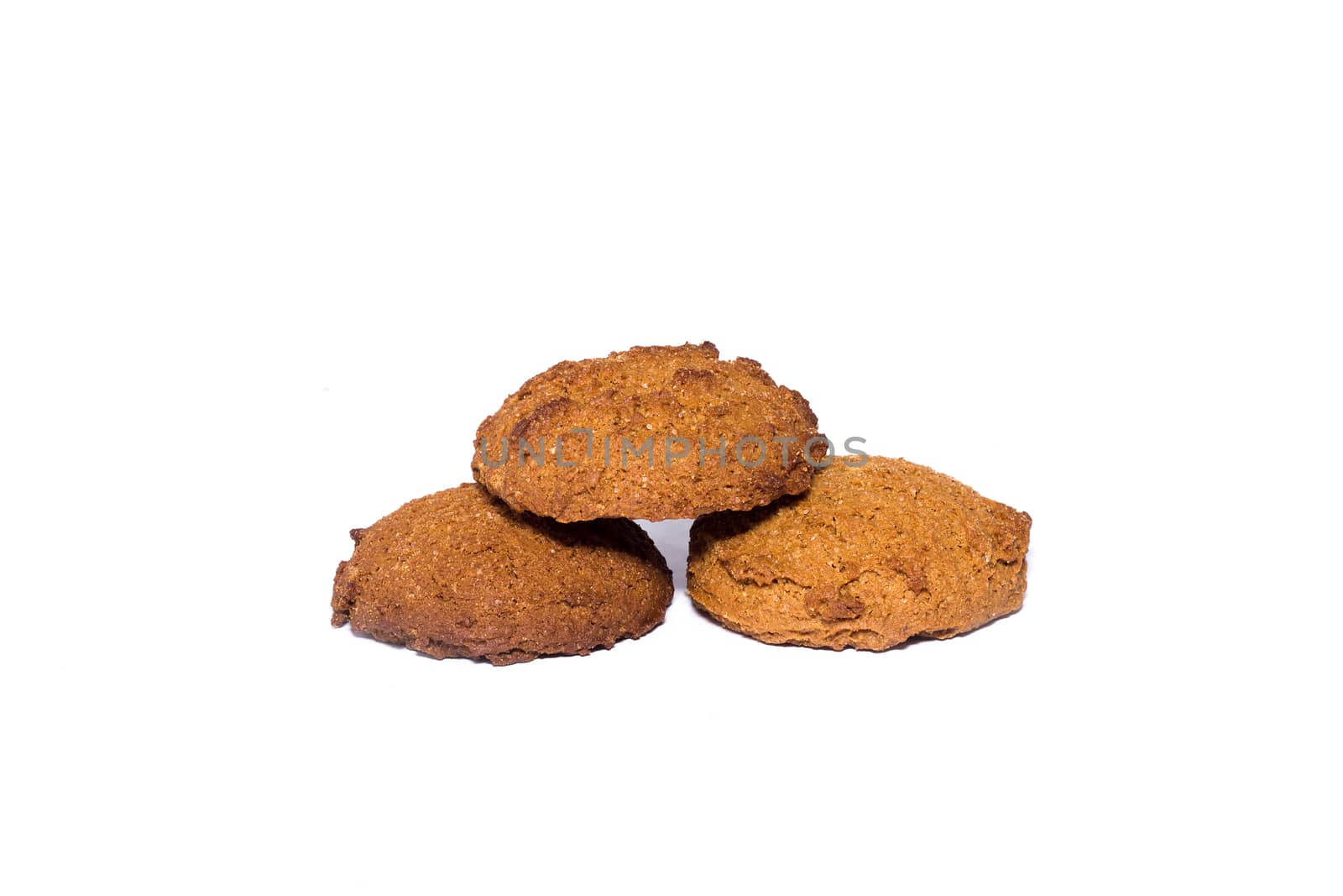 Three oatmeal cookies. Healthy diet isolated on white background.