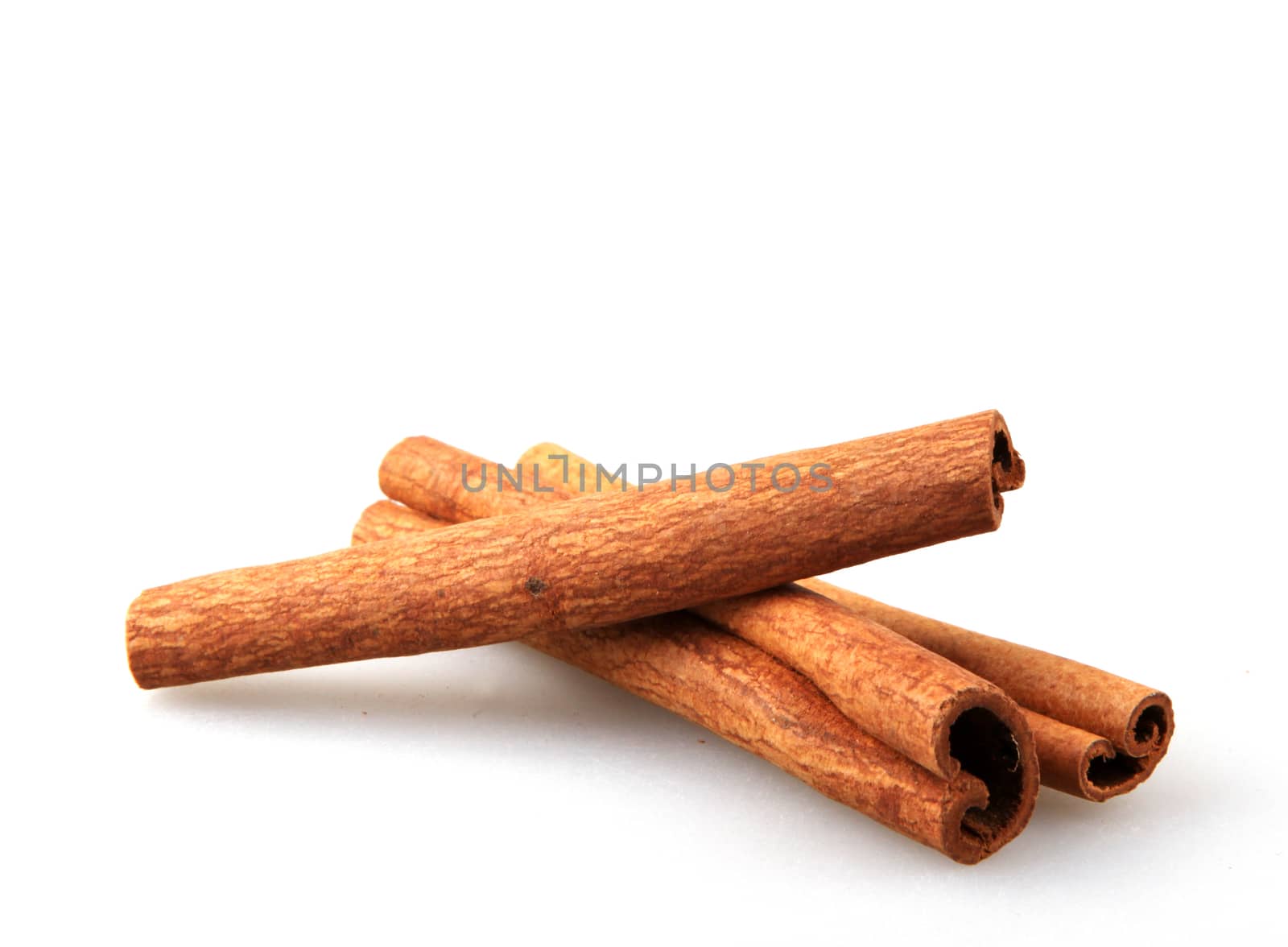 Cinnamon Sticks Isolated On White Background by nenovbrothers