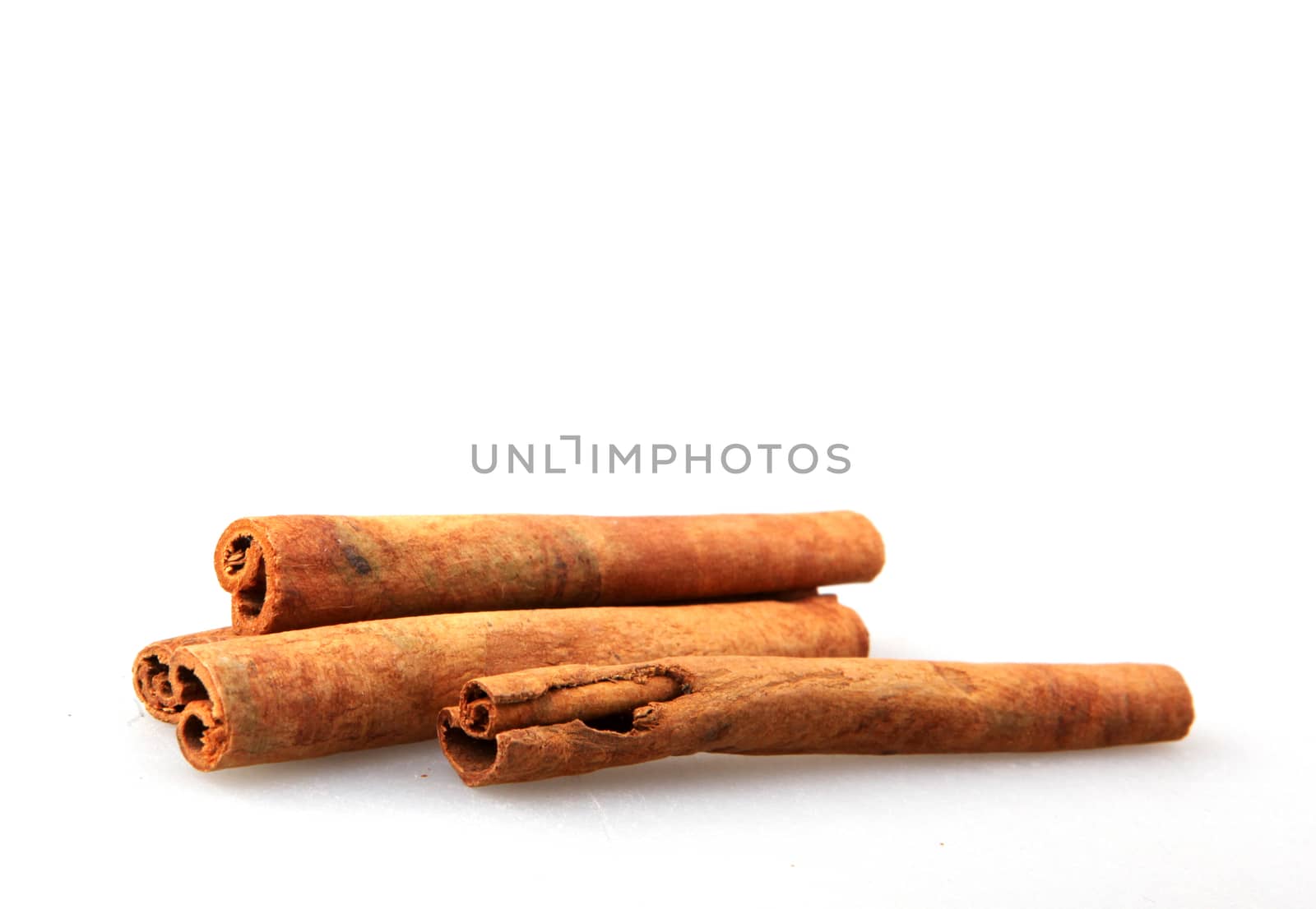 Cinnamon Sticks Isolated On White Background by nenovbrothers