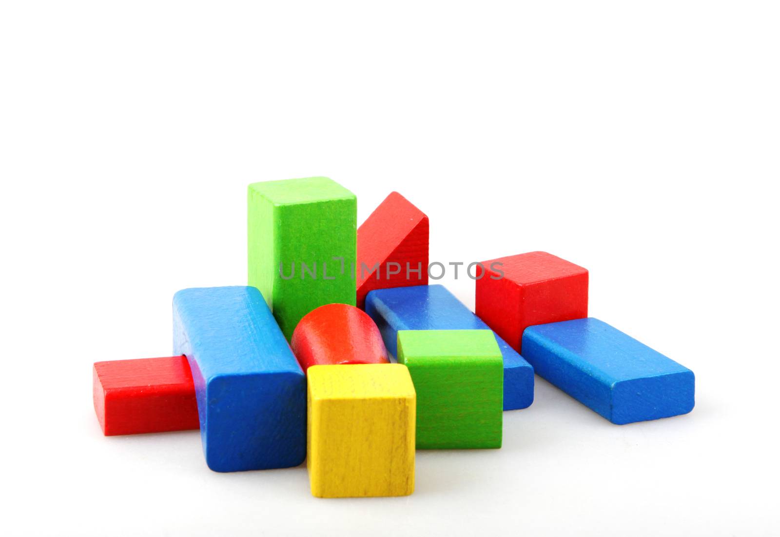Studio Shot Of Colorful Toy Blocks Against White Background by nenovbrothers