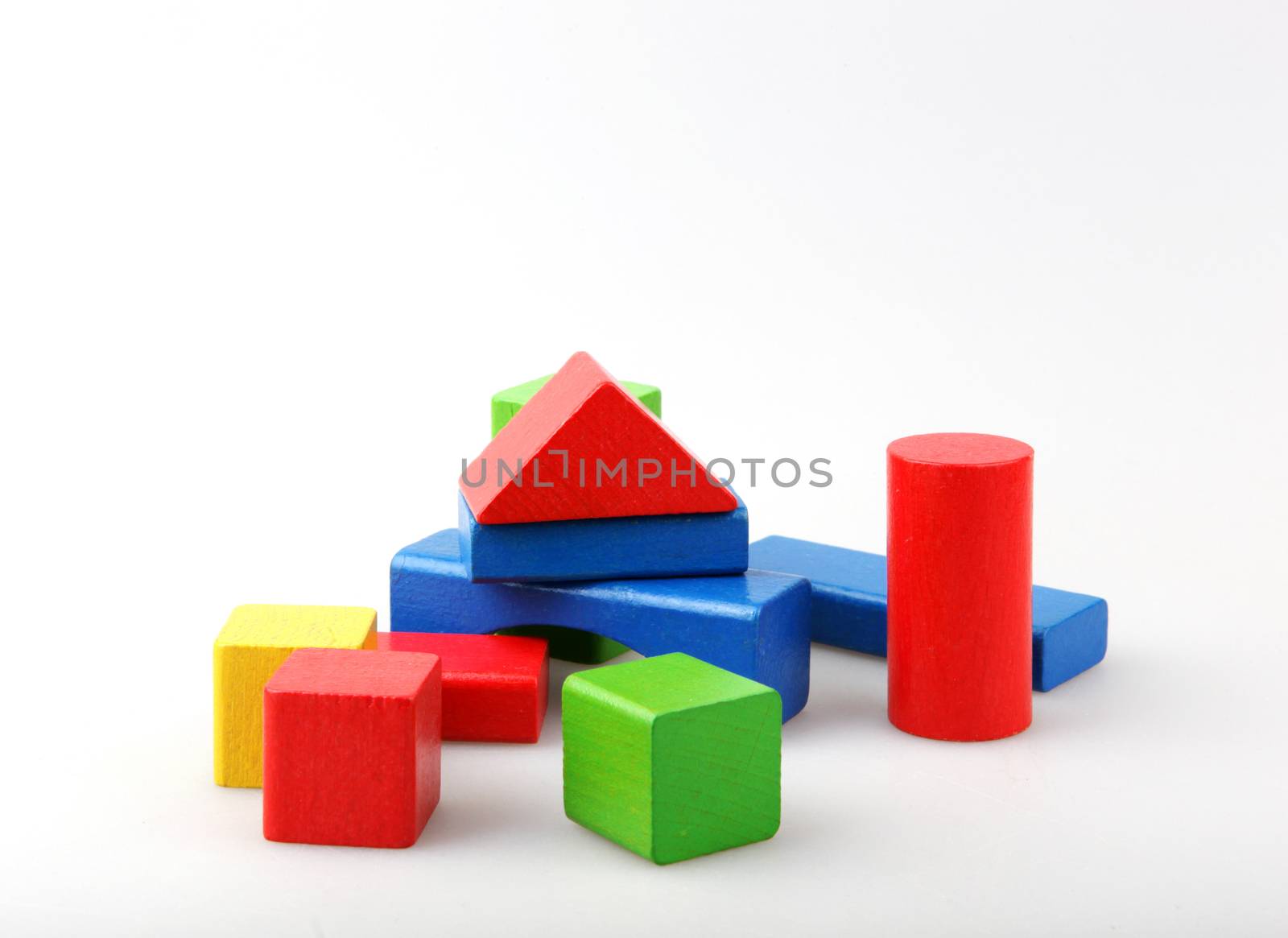Studio Shot Of Colorful Toy Blocks Against White Background by nenovbrothers