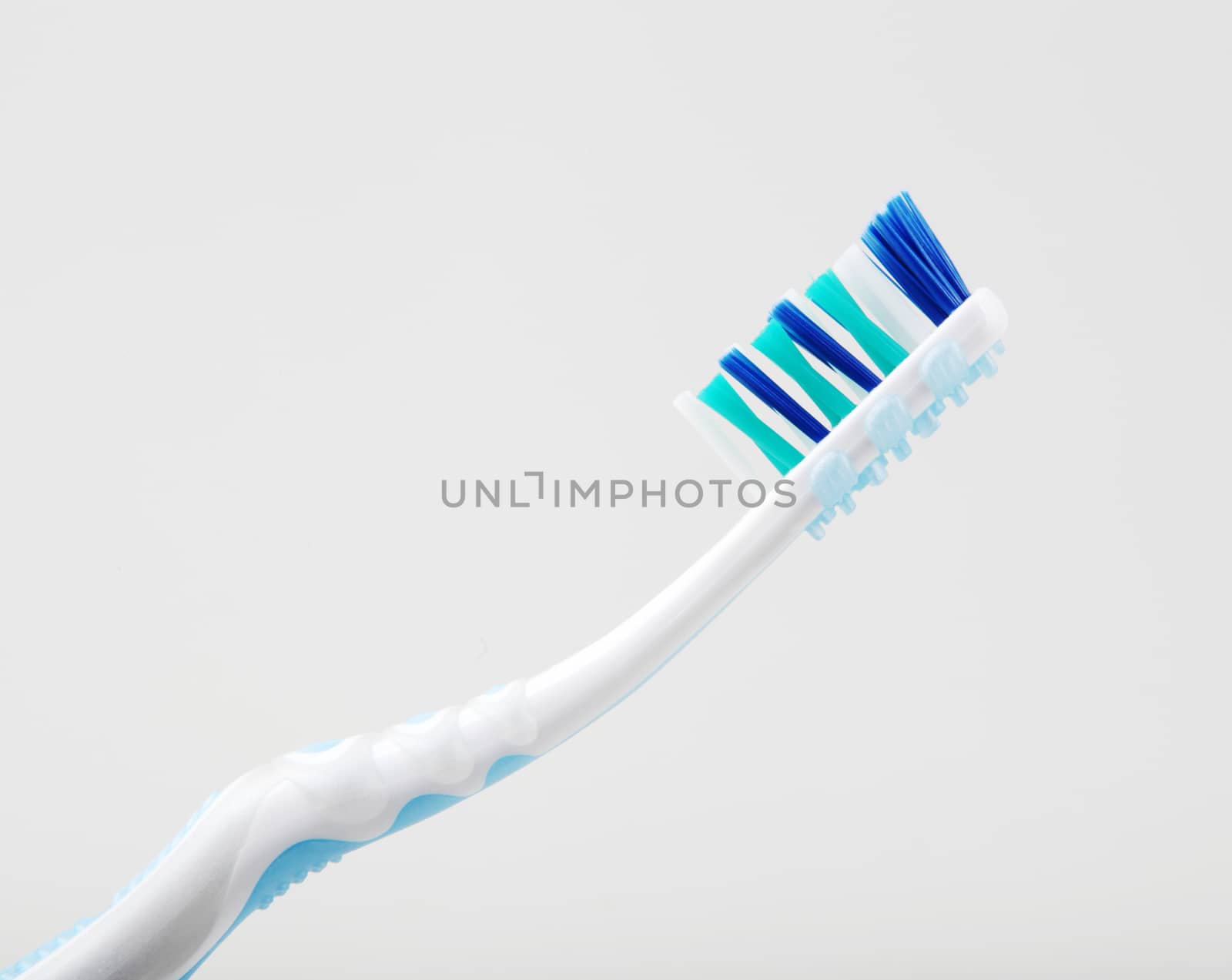 Plastic Toothbrush Against White Background by nenovbrothers