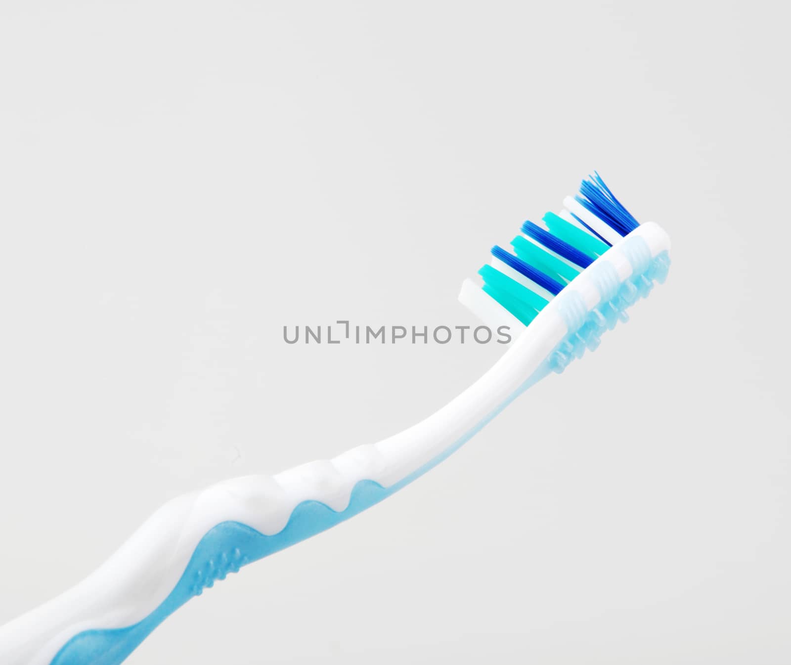 Plastic Toothbrush Against White Background by nenovbrothers