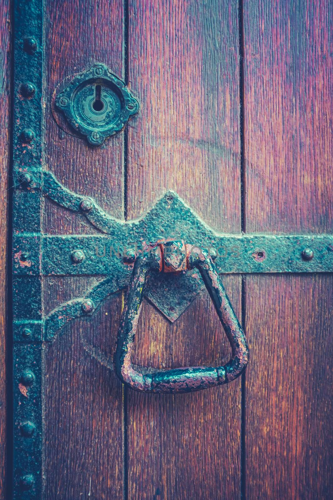 Ancient Heavy Door At A British Medieval University With Iron Handle And Hinges