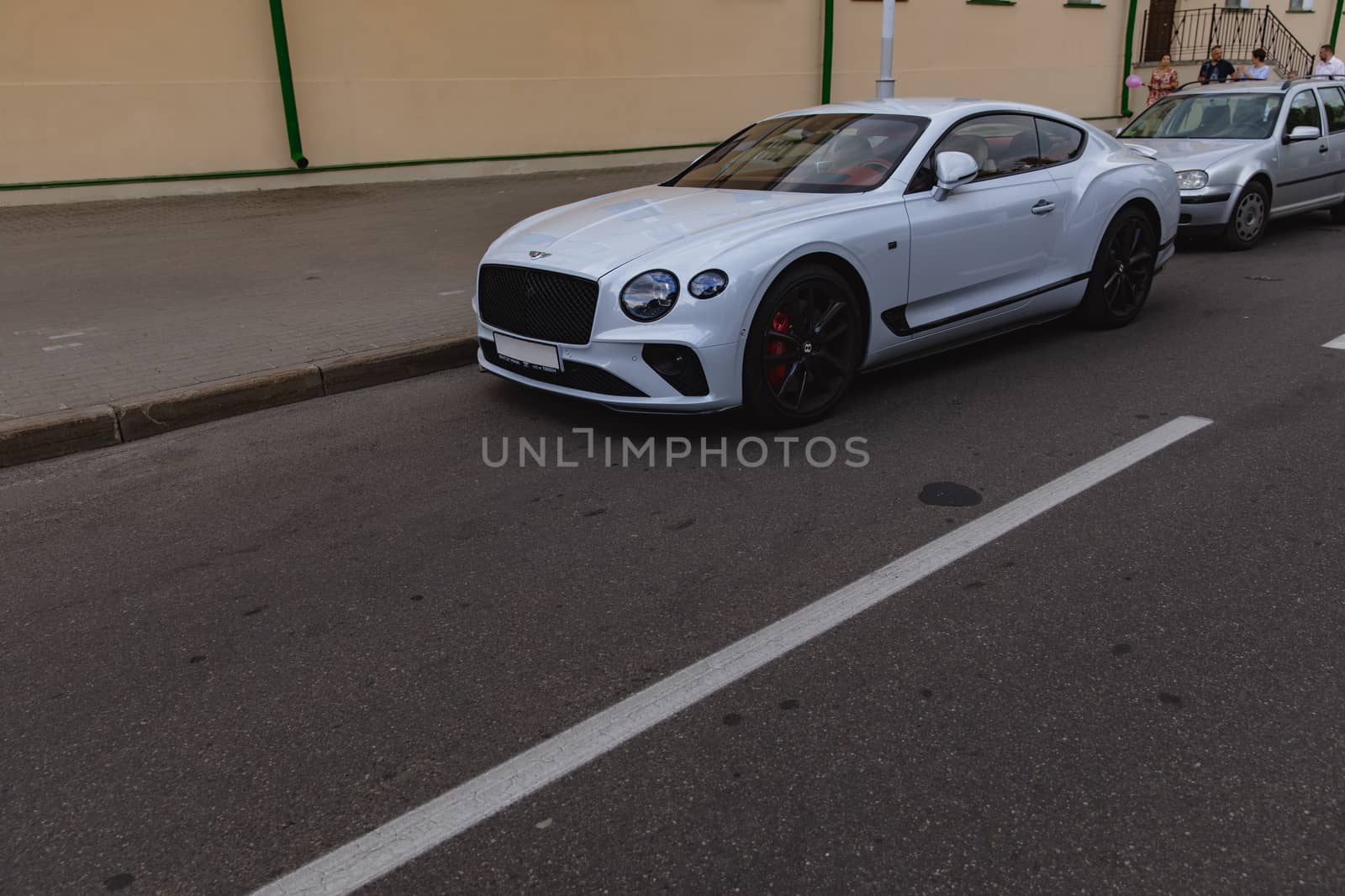 White brand new luxury sport cat Bentley Continental GT 2018 coupe on the streets of European city