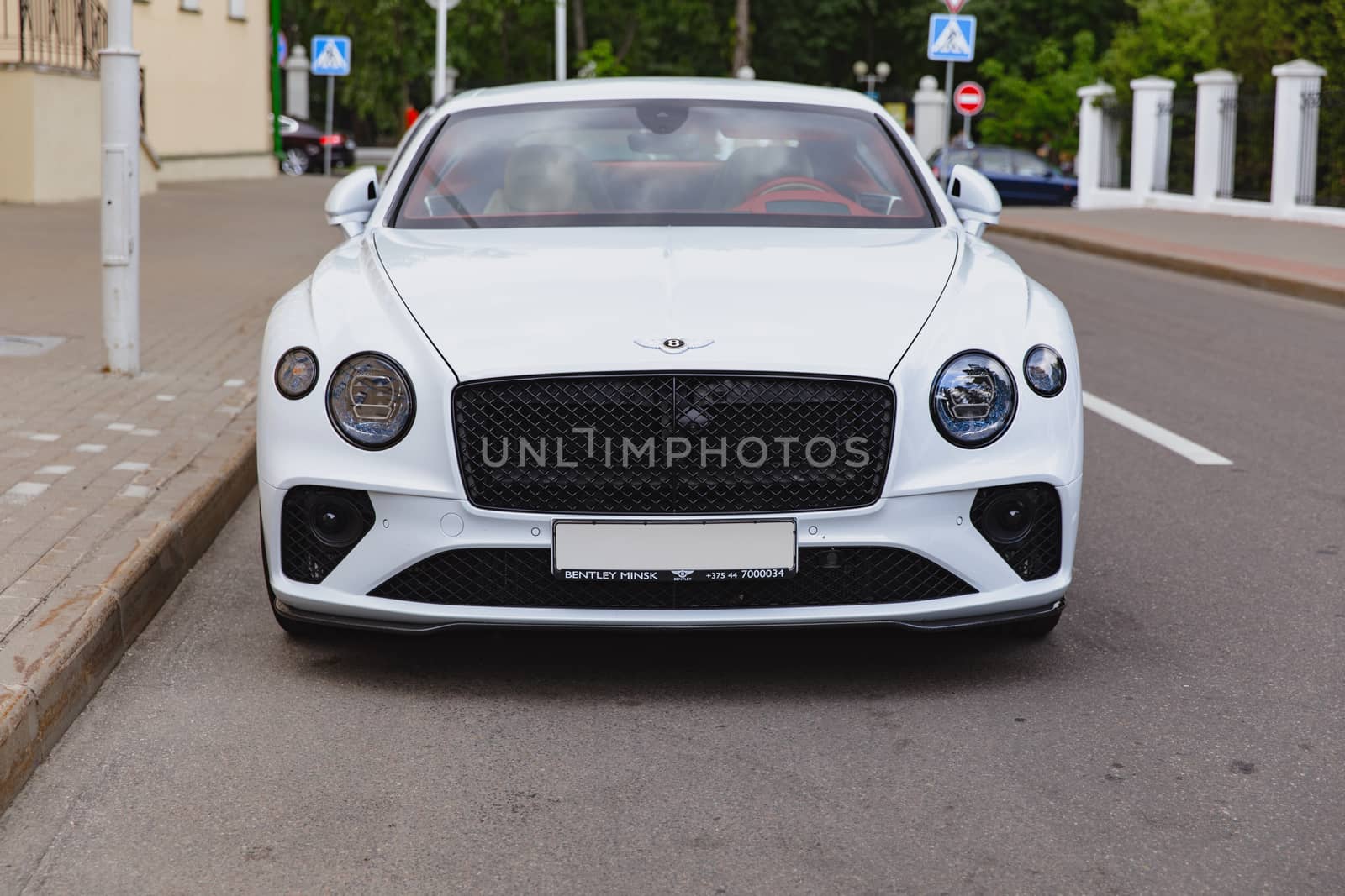 White brand new luxury sport cat Bentley Continental GT 2018 coupe on the streets of European city