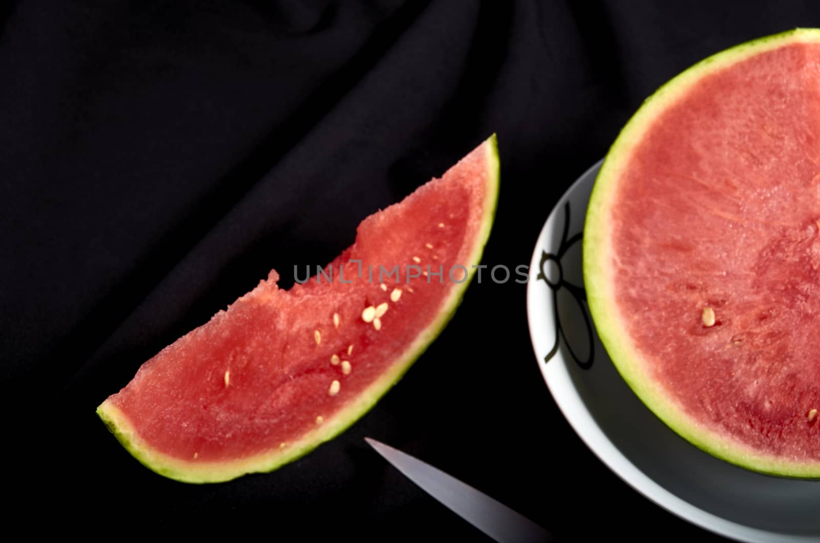 Image slice of watermelon with bite black background