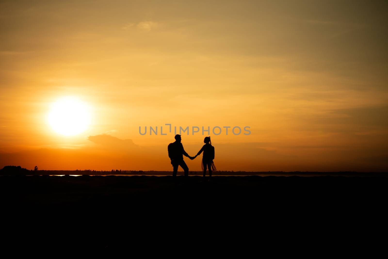 Silhouette traveler couples walking  on mountain at sunset times