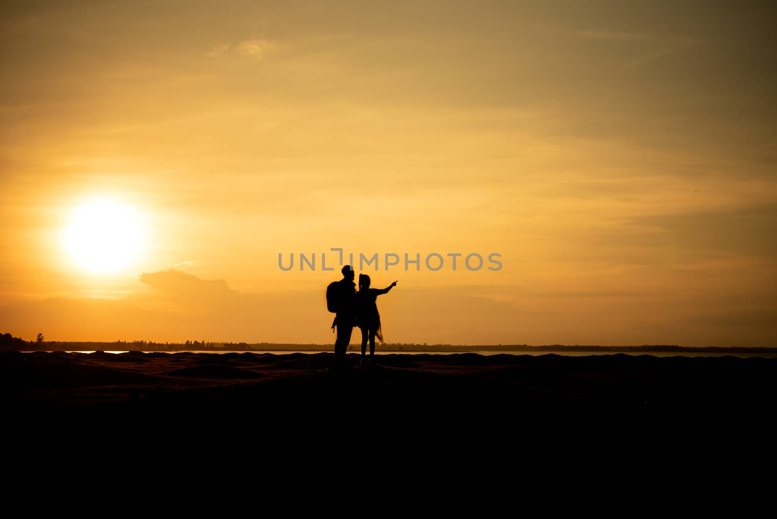 Silhouette traveler couples walking  on mountain at sunset times