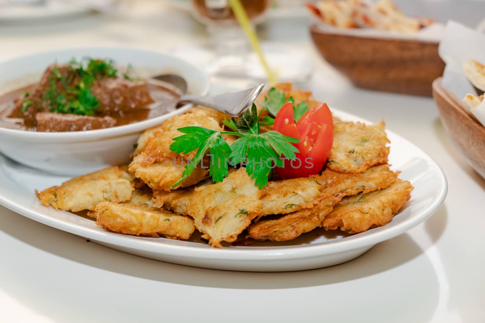 National Jewish dish - Fleish mit latex - beef stew with potato pancakes