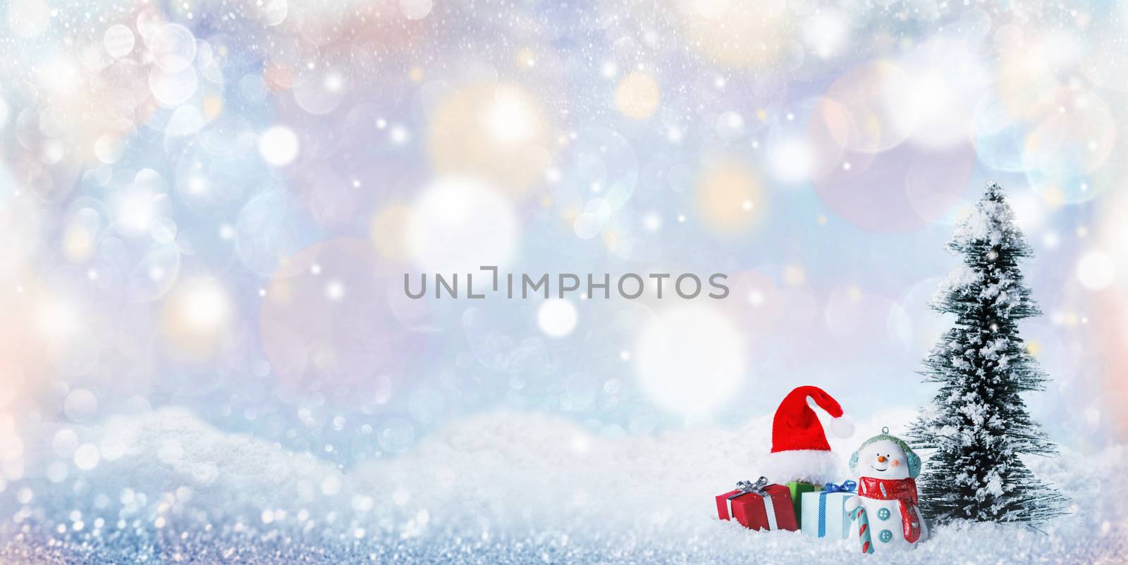 Snowman fir tree and christmas gifts on sleigh on snow, falling snow bokeh background